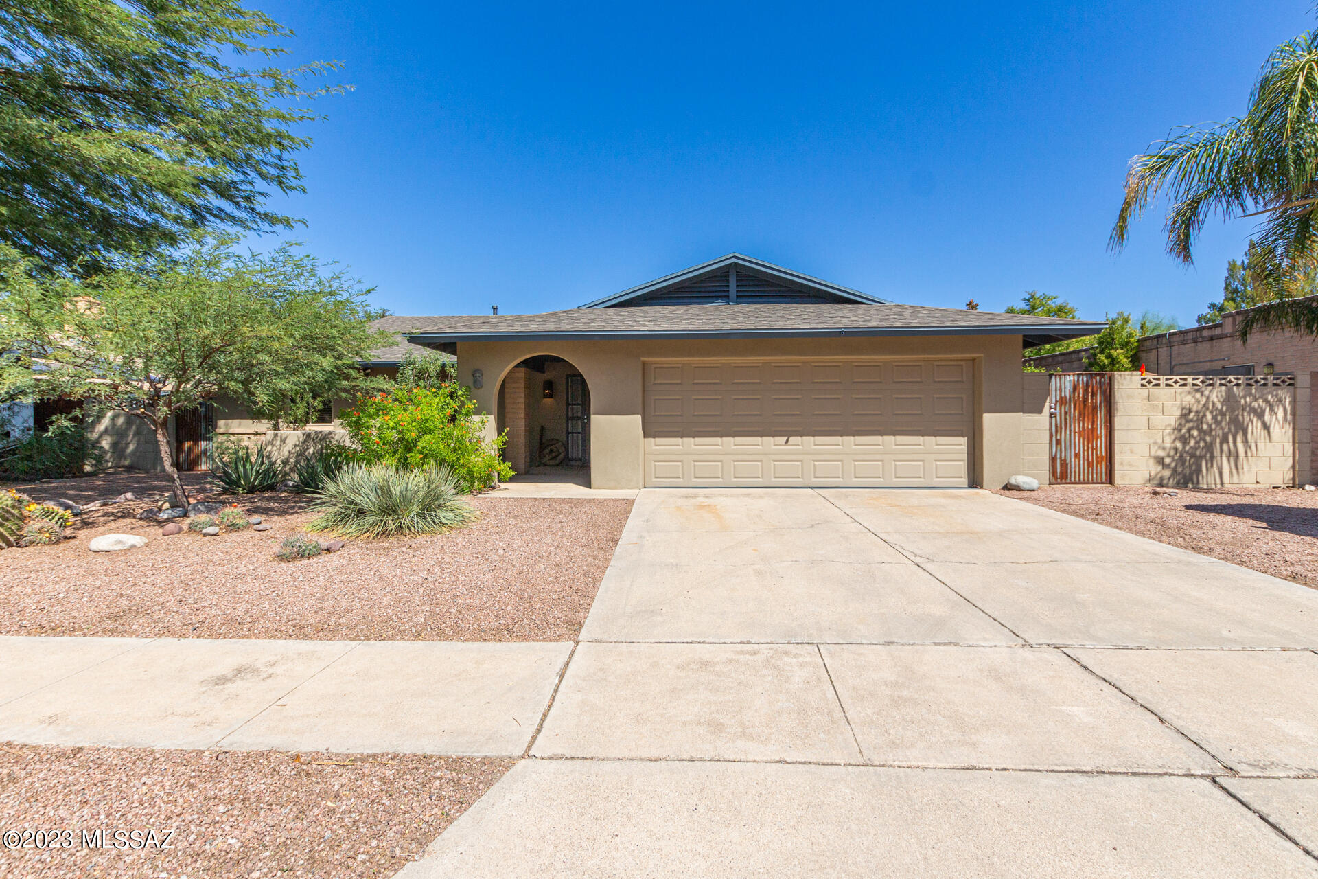 Fall in LOVE with your new desert oasis! This home is in excellent condition, within minutes of Udall Park, shopping and bike paths up and down the Pantano ''River''. Enter to find a desirable great room with a beehive fireplace, tile flooring, recessed lighting, designer paint. The kitchen boasts ample wood cabinetry, a custom breakfast bar w/pendant lighting, and built-in wine cooler. The bonus living room with endless natural light gives access to a salt pool w/ heater on one side and to a party patio with sink, fridge, storage and fire pit on the other. Front offers RV parking with hookups, and an extra 24' space for other toys! Garage has private workshop area. Upgrades-New roof in 2020, Pebble tec pool, decking & appliances 2022. New HVAC in 2022. Range Price $449,900-$469,90