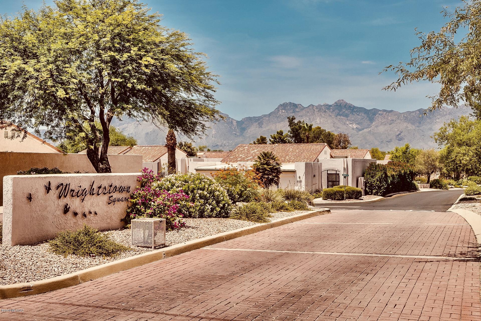 This 2 Bdrm, 2 Bath TH  is located in the sought after Community of Wrightstown Square. A perfect NE location nestled in the Catalina Mtns. offers a year round saltwater heated pool, spa, along with entertainment Gazebo, outdoor kitchen, beautiful common areas & mature plantings Feels like you're on vacation all the time! Architectural details greet you as you enter the  home w/ soaring ceilings, arches and open floor plan.  The Greatroom/ Dining area has a charming fireplace and French door entrance to the generous patio, backs to open space & a slice of the Catalina Mtns. The large kitchen has a Breakfast nook with add'l storage leading to the 2 car garage, laundry facilities &  more additional storage..No Polypropylene pipes! Easy to show & sell!
