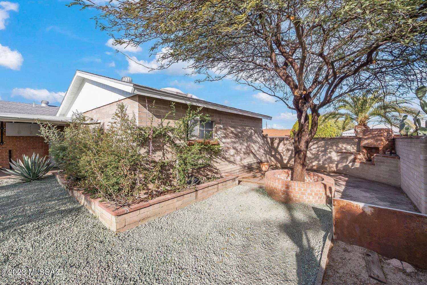 PRICE Reduced- Beautifully renovated light & bright MOVE in Ready red brick home with additional INCOME property potential. Detached extra large Garage (approx. 24'x24'x14') w/ separate entrance could be converted to guest house -200amp service to property (water/sewer are just feet away) New RHEEM HVAC 2023, Owner OWNED SOLAR (28 panel installed 2015). New Roof (Feb 2023)  This move in ready 3 bedroom - 2 full bath home also includes a large (approx.) 10'x 20' DEN with wood burning fireplace providing plenty of additional space for the entire family. All new SS appliances, granite, new bathrooms, new lighting, fixtures, flooring, Interior paint, and most windows replaced throughout. This lovely Home sits on a corner lot with a circular drive, Brick Fire pit,  Alley access, extended rear patio and tool shed, mature vegetation, shrubs and trees throughout the property-  **** Plenty of room to build out laundry room in shed or garage.