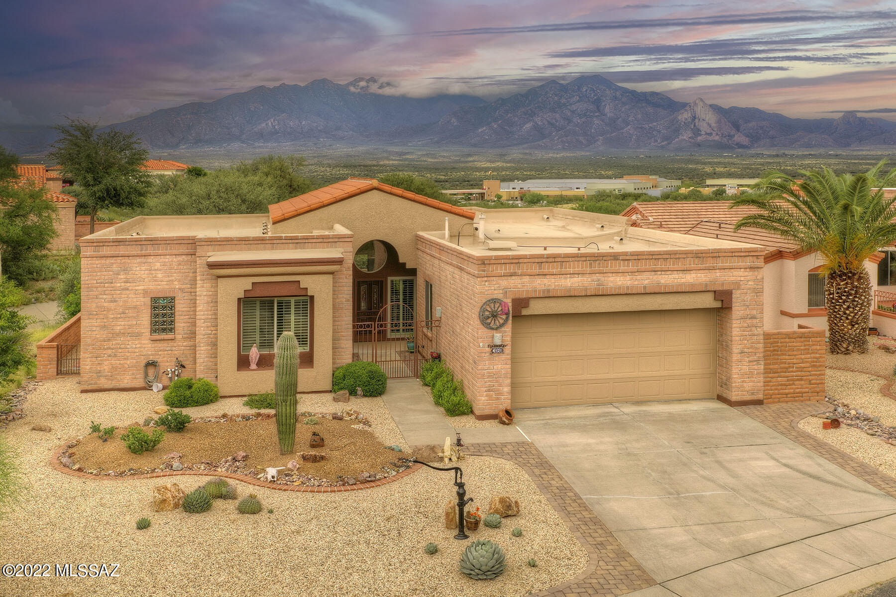 Unobstructed Santa Rita Mountain VIEWS in this gorgeous, completely updated home!  Luxurious finishes and and soaring ceilings are framed by oversized windows that bring the natural light and views deep into the interior. Curb appeal abounds as guests arrive and enter the beautifully done front courtyard.  Entering into the living room, they will be awed by the spectacular mountains that greet them!   The patio is the heart and soul of this home with its breathtaking views and beautifully finished space. A gurgling fountain and red pavers create ambience, inviting memories to be made.  Back inside, the formal dining area looks directly onto the views and the kitchen is the perfect place to gather with family and friends.  Stunning custom wood cabinetry and plenty of space make entertainin A joy!  The office is adjacent and hidden from the main entertaining areas of the home.  Guests will love the privacy and updates of their ensuite, complete with an impressive tiled walk-in shower.  Retreat to your owners suite where you can gaze at the mountain views every morning.  A spa-like bath welcomes you after a long day.  Your home should be your sanctuary, allowing you to live your next journey in life with beauty, elegance and ease.  If this is your dream, then this is your home!
