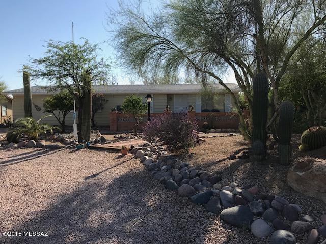Marvelous location for this 1344 SF Manufactured home, 2 bedrooms 2 full baths.   full length porch for sunset and mountain views.   Workshop in back for storage and projects.  Saltillo '' super'' tile throughout.  Location faces the mountains and situated on .17 of an acre.   Awesome walking neighborhood tucked high up in Tucson Estates #2.  This area is NOT age restricted and mixed with single family homes and manufactured homes.  Priced to sell as-is.