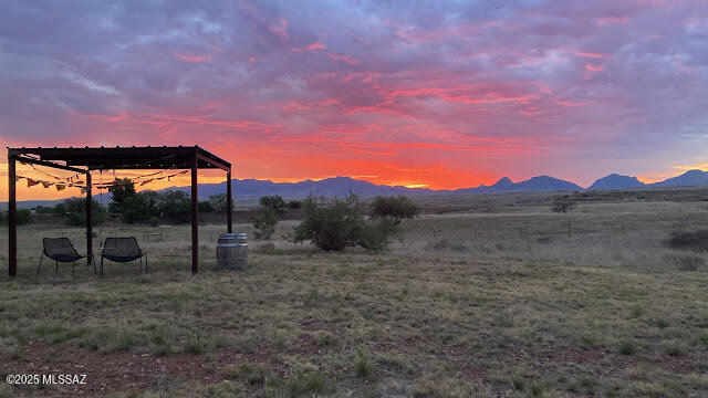 Great place to hangout and watch the sunrise and sunsets in Southern Arizona wine country. Mountain Views!, Aprox 2 miles to businesses in Sonoita. Access to Local wineries, Empire rec area, National Forest and Patagonia or Parker Lake. This property is ready for the next stage of development or just enjoy ' AS IS''Fully fenced/gated . Active 6.9 kw Solar Array w/ batteries Powers the storage and solar sheds additional buildings could be added.  A great opportunity to buy into the area with ''Off grid '' Electric, 55 gallon water transfer tank and storage ready to go!