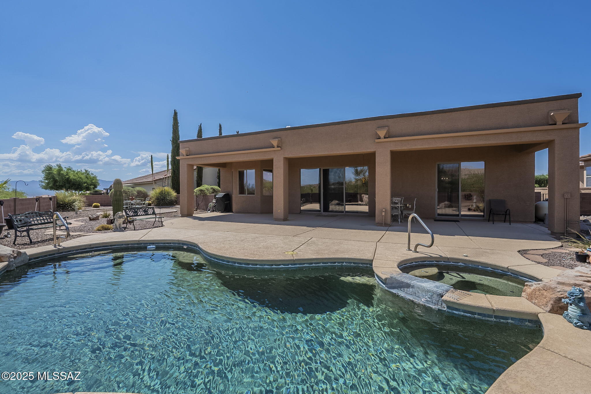 Welcome to your private desert retreat in the highly sought-after 55+ community of Las Campanas at San Miguel in Green Valley, AZ. This beautifully maintained 2-bedroom + den, 2-bath single-family home offers an open great room concept, perfect for both easy living and entertaining. A dramatic 12-foot sliding glass door opens to your backyard oasis, featuring a Pebble Tec, solar-heated pool and spa, fully landscaped with desert-friendly plantings for easy care and year-round beauty. With no rear neighbor, you'll enjoy privacy and uninterrupted views of the nearby foothills. From the back patio and courtyard, take in the ever-changing colors of the Santa Rita Mountains — a truly breathtaking backdrop to your desert lifestyle. Inside, the home offers a spacious, airy layout with generously sized bedrooms, a versatile den, and stylish finishes. Just a short distance away, you'll find the Las Campanas Recreational Center, offering a range of amenities including a pool, fitness center, and social events to complement your active lifestyle. This is Arizona living at its best serene, scenic, and designed for those who appreciate the beauty of the Sonoran Desert.