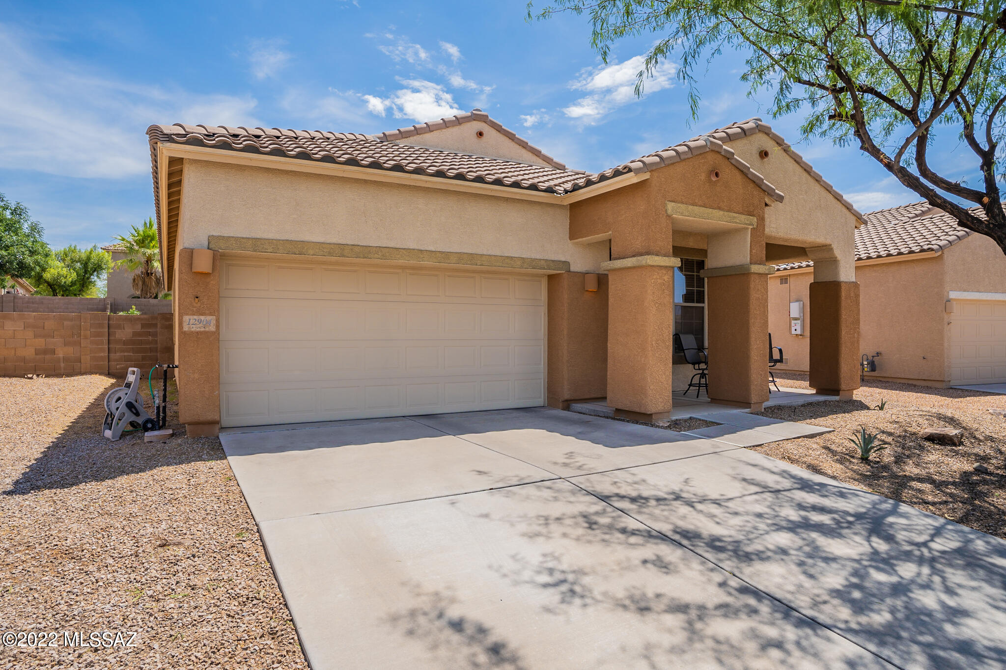 A welcoming and modern yet cozy 3 bedroom 2 bathroom home is now available in sought-after Rancho Vistoso in Oro Valley. Be welcomed by the front porch, and the many comfortable and relaxing spaces in the home.  Enjoy the spacious living and dining areas with lots of room for family gatherings around a large dining table. In the kitchen, find stainless steel appliances, ample granite work space and island, 42'' high cabinetry, and a walk-in pantry. There's also a granite-covered kitchen desk space.  The adjacent laundry room has additional storage. A family room also provides a spot to gather and relax, as does the east-facing and shaded rear yard with a built-in sunshade. The extended primary bedroom features an ensuite bath with tub and shower, and an oversized walk-in closet with built-in shelving. The two rear bedrooms have new carpet and paint, and share the second bath. This home is near all the best that Oro Valley has to offer, with shopping, dining and medical services all nearby. School options include public, STEM and private opportunities. And there is a delightful children's park just down the street.