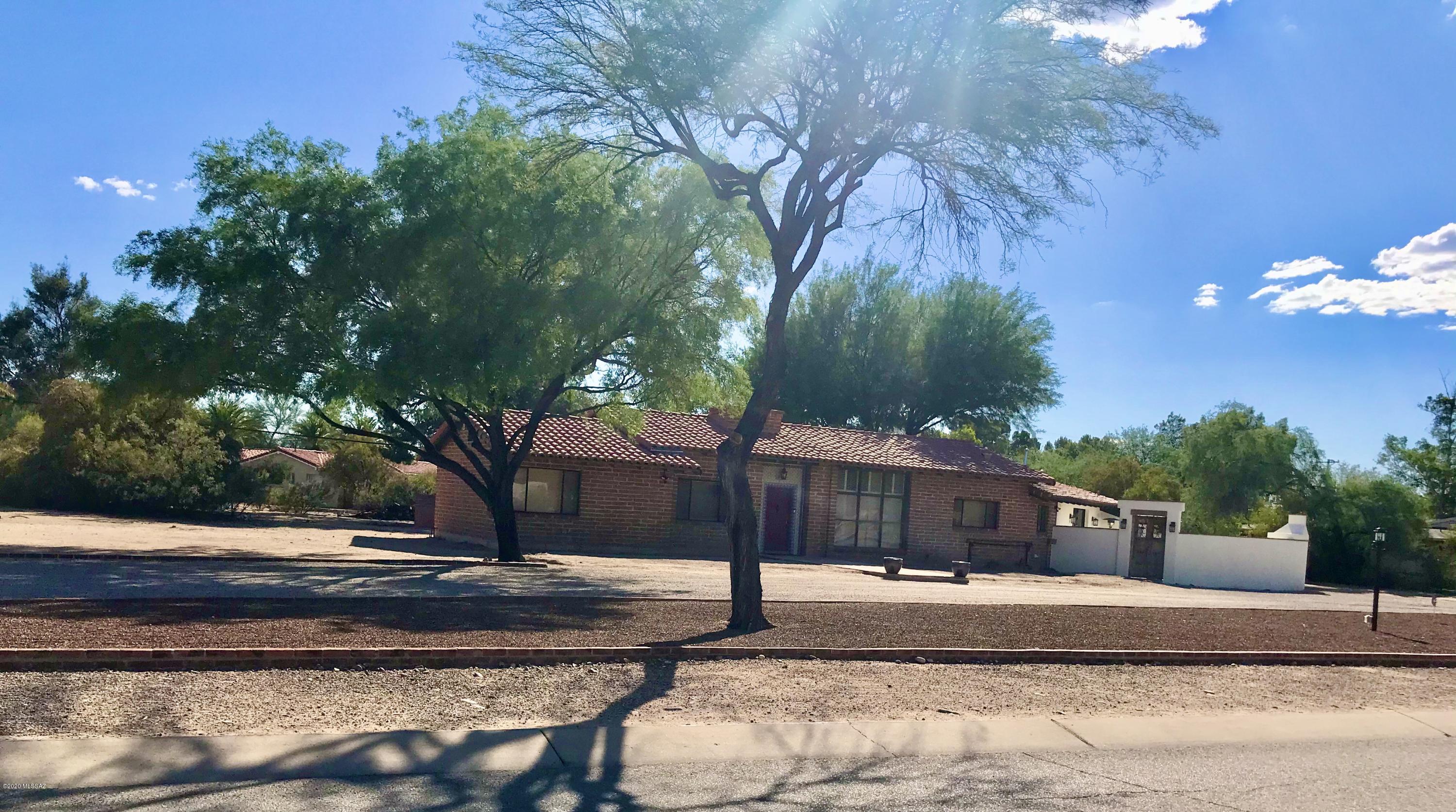 Located on one of the best lots in Tucson CC, this charming hacienda will delight the most discriminating buyers. This spacious home exudes character with Saltillo tile, concrete flooring, high ceilings, lots of large windows to capture the views, 3 fireplaces, mexican tile accents, many built-ins. A recent gorgeous remodel of the Master Bedroom and Bath with a private patio area and huge wood burning fireplace to take advantage of the views.  Architectural plans for future updating are included.  Ideal for entertaining, the Great Room opens to a pleasant Arizona room with flagstone floors overlooking the lush back yard.