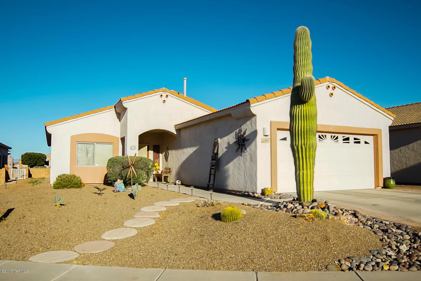 Welcome home to a vast great room with beautiful floor tile, generous windows drawing in natural light and a comfy corner fireplace designed as an old Spanish Kiva. Offering lite separation from the great room, the kitchen has an easy walk-up breakfast bar and serving platform for the adjacent open dining area. Step into the “U” shaped kitchen where you’ll find abundant elbow room, gleaming quartz countertops and stainless steel appliances. Your master bedroom suite offers enough space for a sitting area or computer area and the master bath has dual sinks and lengthy countertops with a built-in makeup station. Double French glass doors take you into a den where you can catch up on bookkeeping or computer work. And, the backyard is a perfect place to relax on a covered patio to enjoy the changing colors dancing off the Santa Rita Mountains at sunset. Come take a look and call this your new desert home!