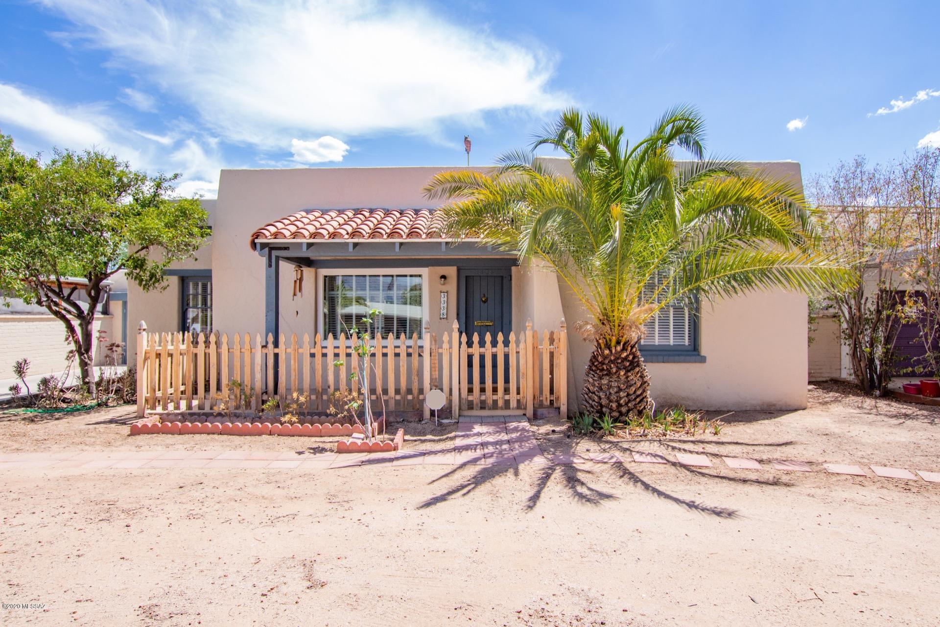Charming 1936 Bungalow w/a picket fence & detached 1 car garage. Lots of character throughout! Handsome original hardwood floors, retro built-in shelves, cozy wood burning fireplace, window blinds, fresh palette, & French door to an amazing Arizona room w/endless possibilities! Formal dining area & stunning kitchen w/gray cabinets, tiled backsplash, open shelves,  & upgraded lighting, 2 Large bedrooms & original claw foot tub, vessel sink,  wood vanity in the main bathroom.  Spacious backyard has plenty of room for a pool, garden, & toys! Own a piece of History!
