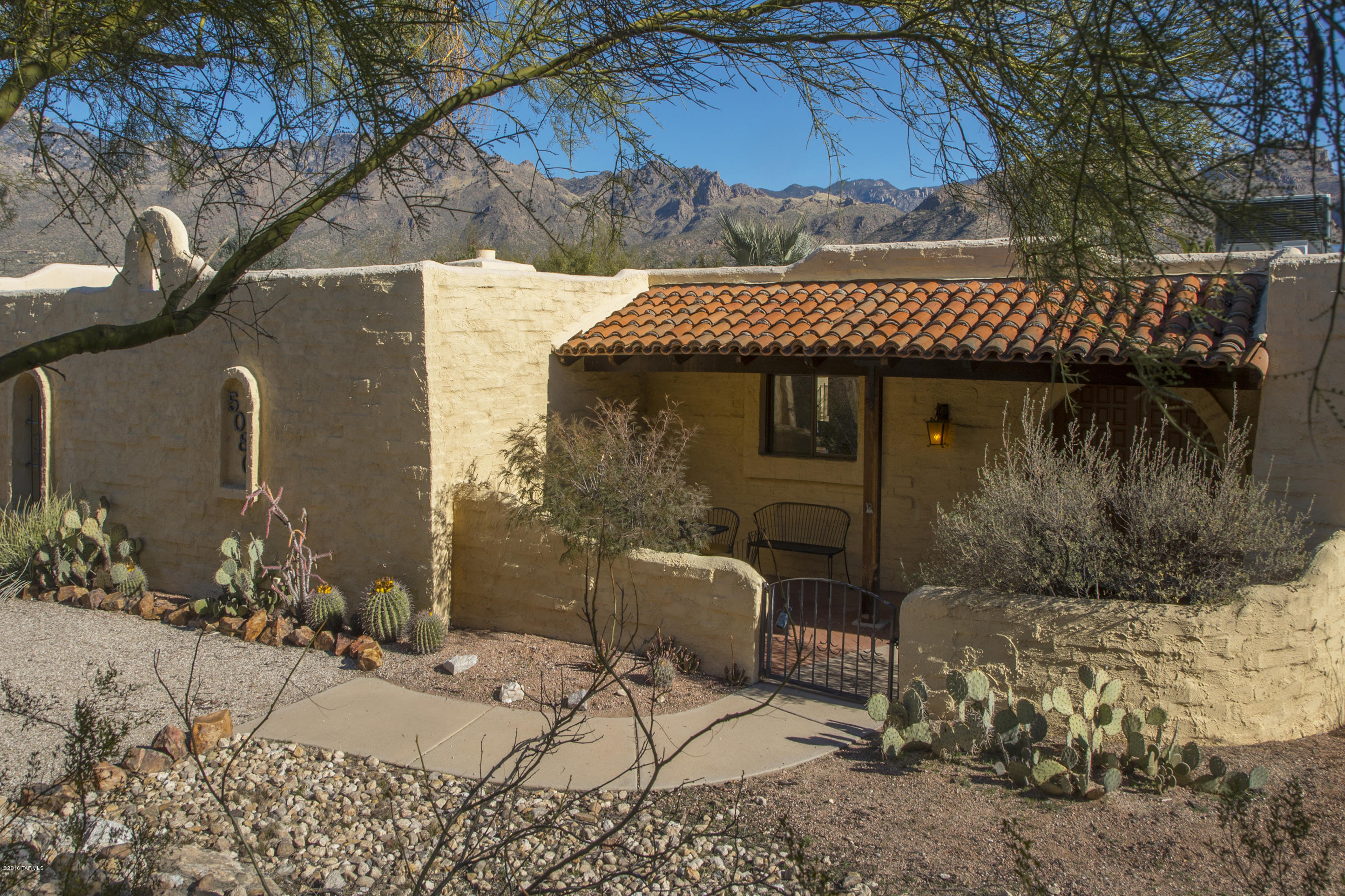 Wonderful territory style ranch home on private cul-de-sac street. This home has been lovingly cared for offering 3 spacious bedrooms, formal living/dining and family room area with fireplace.Traditional saltillo flooring in the kitchen and carpet in the bedrooms and living areas. There is a pool with child safety fencing. Dynamite views of the Catalina Mountains. Popular Dist 16 schools.