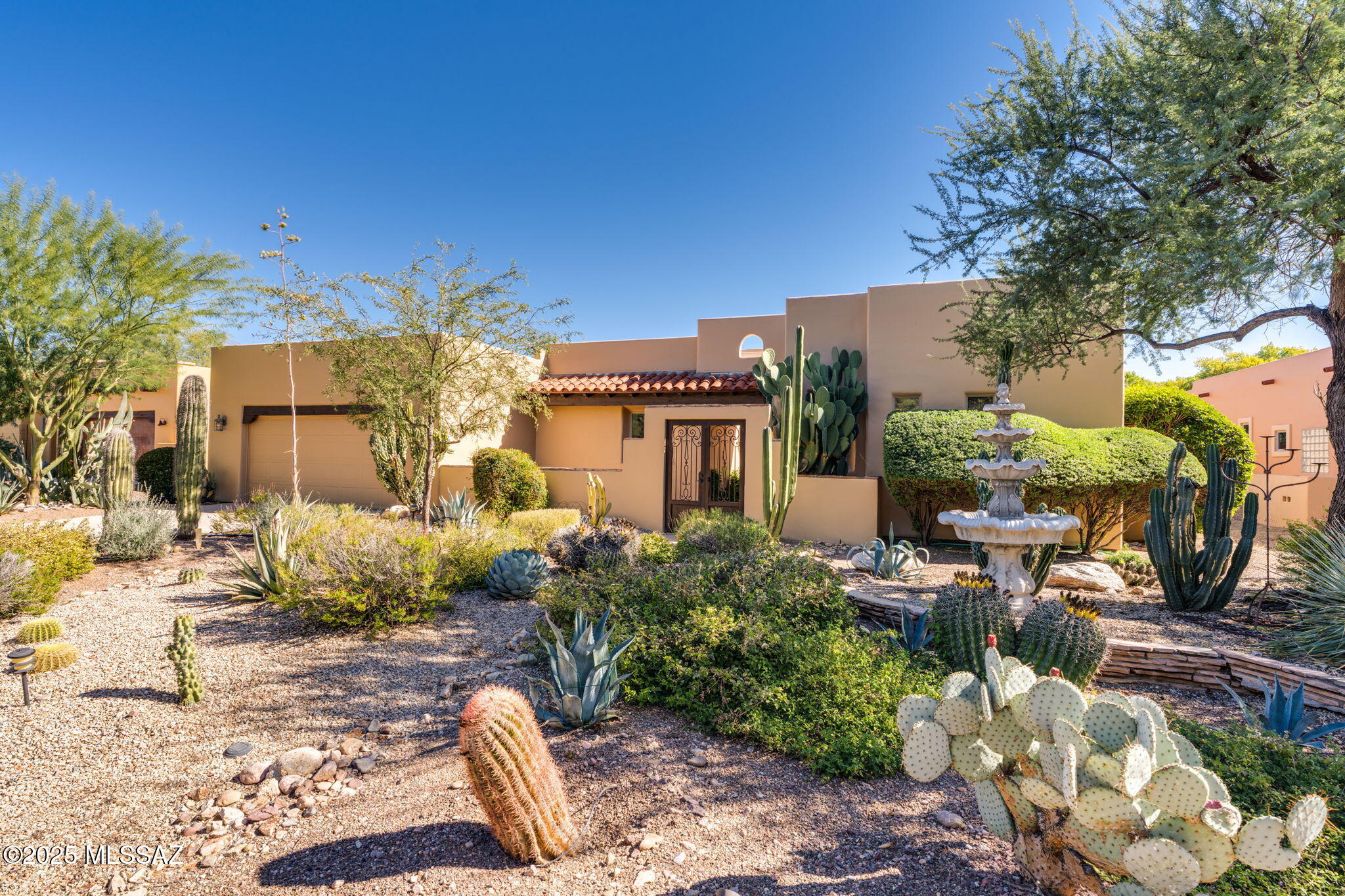 Stunning Hacienda Model with casita on a premium .40-acre lot backing to the De Anza Trail and Santa Cruz River with views of lush cottonwoods. The 2,146 SF main home plus 329 SF detached casita offer space and flexibility. Custom tile work, artisan sinks, a flagstone courtyard with fountain, and three fireplaces (one inside and two out) create timeless charm. Expanded patios and a sky deck invite outdoor living and star gazing. The backyard is an entertainer's dream with a full outdoor kitchen, natural gas BBQ, and solar-heated pebble tech pool.