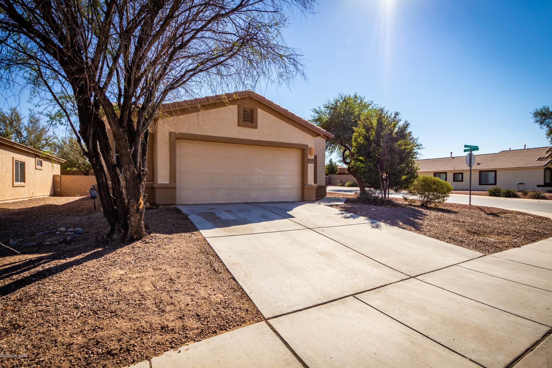 Beautiful and well maintained Marana home available in highly sought after Gladden Farms. 3 bedrooms, 2 bathrooms with high ceilings, neutral paint tones and soft natural lighting throughout. Spacious living area is enhanced with a charming fireplace. Eat in kitchen is complete with a pantry, lots of cabinet and counter space and a sunny dining nook. Low maintenance tile and soft plush carpet in all of the right places. Bedrooms are generously sized and the master includes a walk in closet and a full en-suite. Huge backyard offers a covered patio, block fencing, and plenty of room for pets, play, gardening, and so much more. Its the perfect spot to create the outdoor space of your dreams. All just steps from beautiful community parks and minutes from the I-10. See it today.