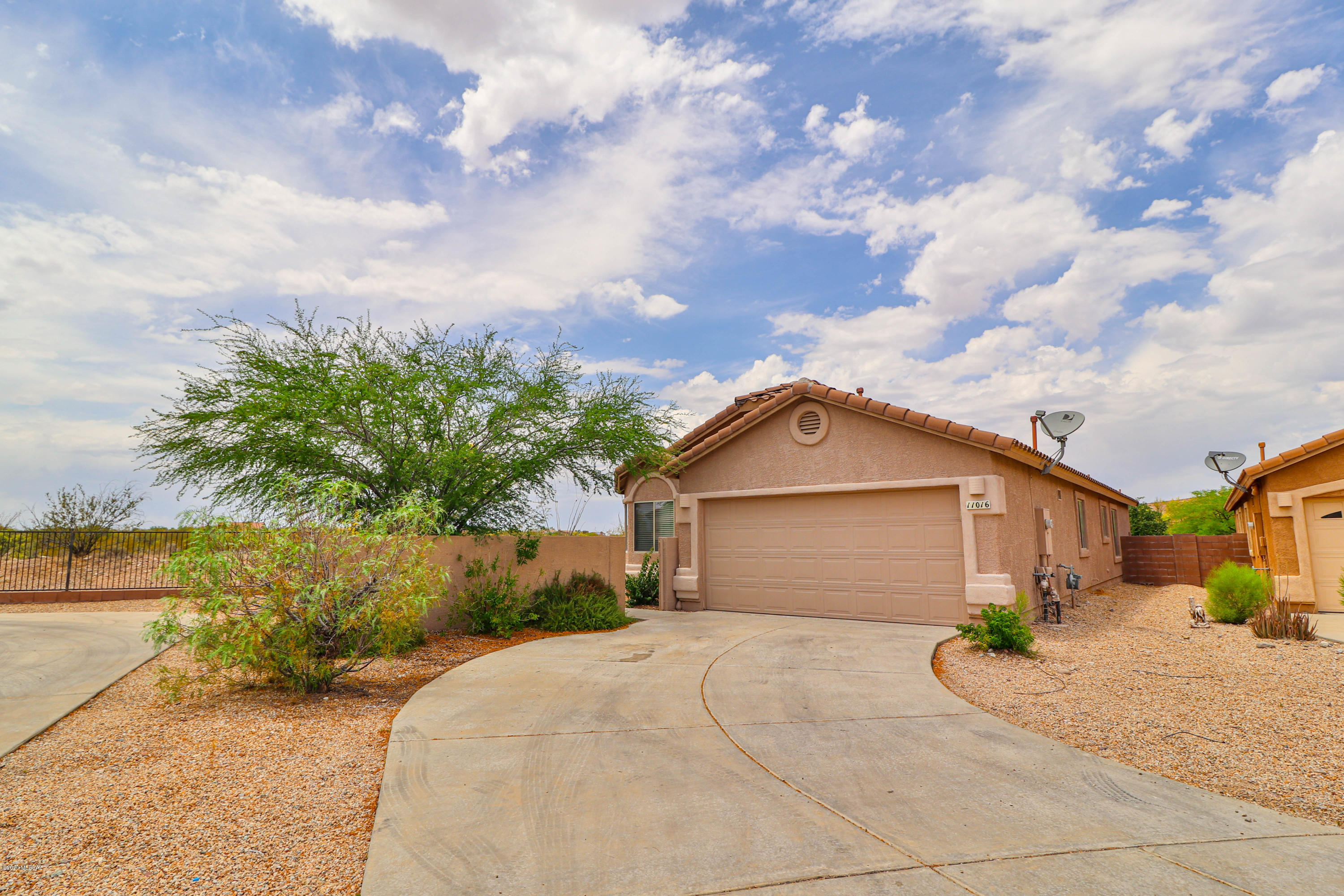 Move in ready 3 bed, 2 bath home in Rancho Del Lago!  Vail School District!  Home features 18 inch tile and wood laminate thru majority of home with carpet in the bedrooms!  Bonus office/den off the living room!  Wide open kitchen with perfect amount of cabinet space!  Master bedroom upgraded with 2 individual pedestal sinks!  Split floor plan for extra privacy!  Private lot with only one neighbor to the NE!  Gated courtyard in front yard!  Huge backyard with pavers, covered patio,  and flagstone! Mountain Views!  Schedule your showing today!