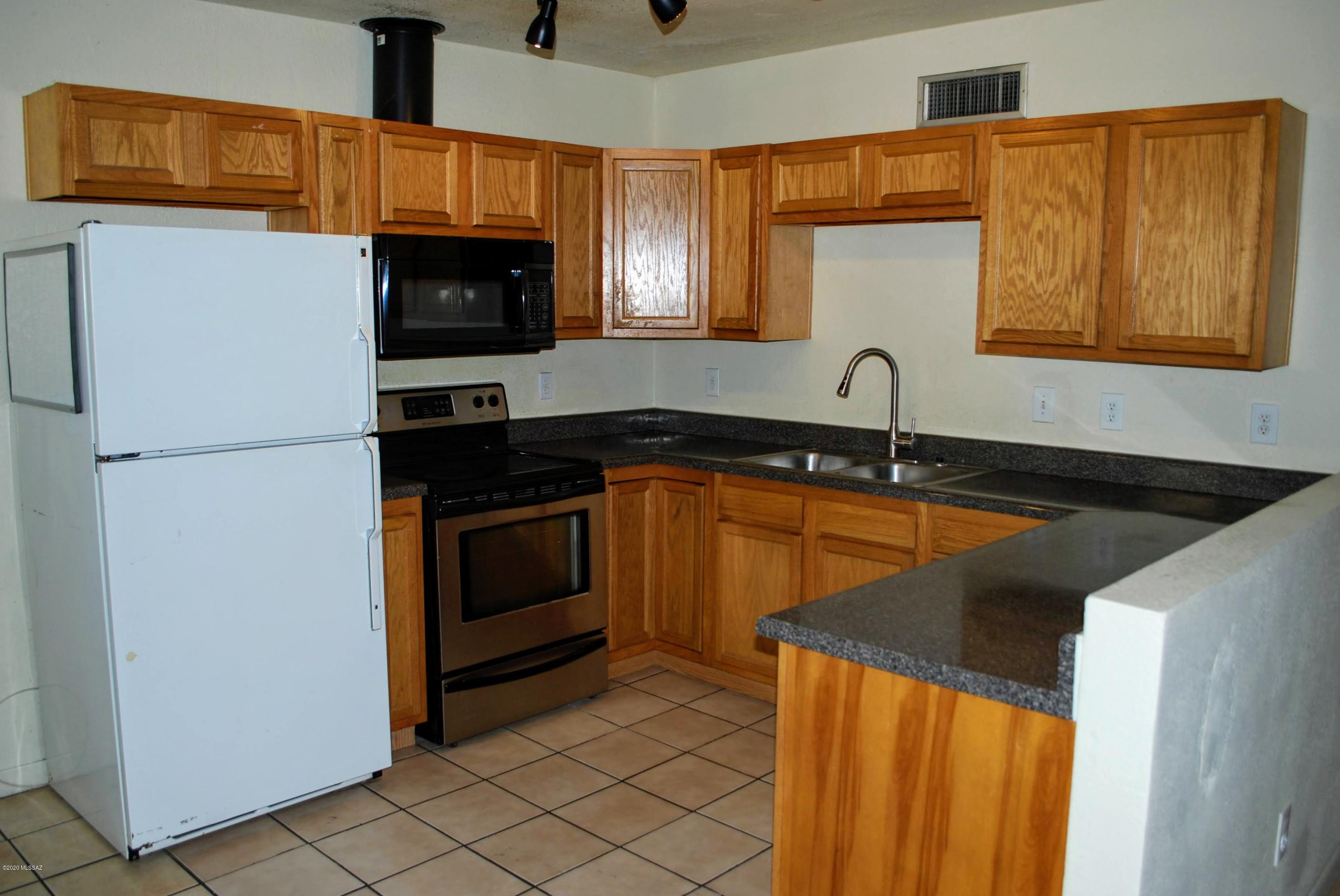 Walk or Bike to the UofA from this 2 Bed 1 Bath Duplex. Less than 1 Mile to campus and Quick Drive to Downtown Tucson and 4th Ave. 745 SQ FT Huge Private fenced yard with custom wrought iron fencing and covered patio. 1 covered parking space, shared but FREE washer/dryer. Central A/C & Heat. Open concept living/dining/kitchen area with breakfast nook. ALL TILE, NO CARPET. Updated bathroom.Pets subject to owner approval. This unit is offered as NON-SMOKING.