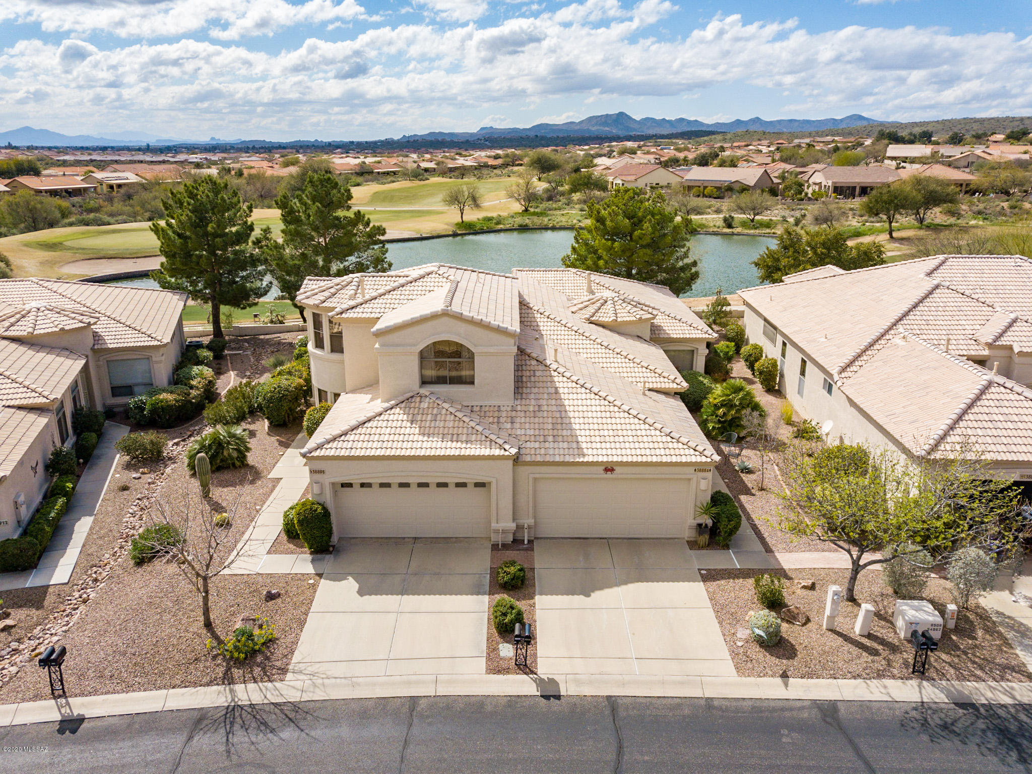 Searching for a maintenance free lifestyle with an incredible views and stunning floor plan?  This luxurious 2 story villa overlooks the lake on #8 hole of Mountain View golf course with stunning lake, sunset & mountain views.  Living Room has towering vaulted ceiling, gas fireplace & access to private patio with gas FP. First floor Master Bedroom has XLG walk-in closet and access to private, covered patio. Dramatic curved stairway leads to spacious loft surrounded by windows. Private Guest quarters with en-suite bath. Island Kitchen with dining area surrounded by windows. Powder Room, coat closet, laundry room with storage. This former model home is available turnkey so you can move in and start enjoying all that SaddleBrooke has to offer.  Exterior maintenance & landscaping by HOA.