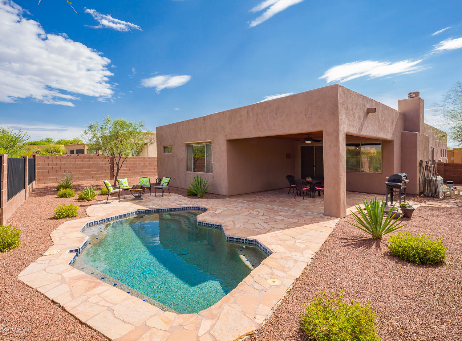 From the moment you walk through the front door, the upgrades & finishes in your new home will impress. Ceramic tile throughout the entire house except the bedrooms. Nicely upgraded kitchen with Corian counter tops, ample storage & custom hardware on the cabinets. The open & bright great room leads to the east facing back yard with terrific Rincon Mountain views. Plenty of shade for the entertainers dream of the yard complete with a heated pool, flagstone patio, no neighbors behind the house and more! The master suite has a large shower & a walk in closet. Double door den. Front room would make a great office. Make this home yours today!