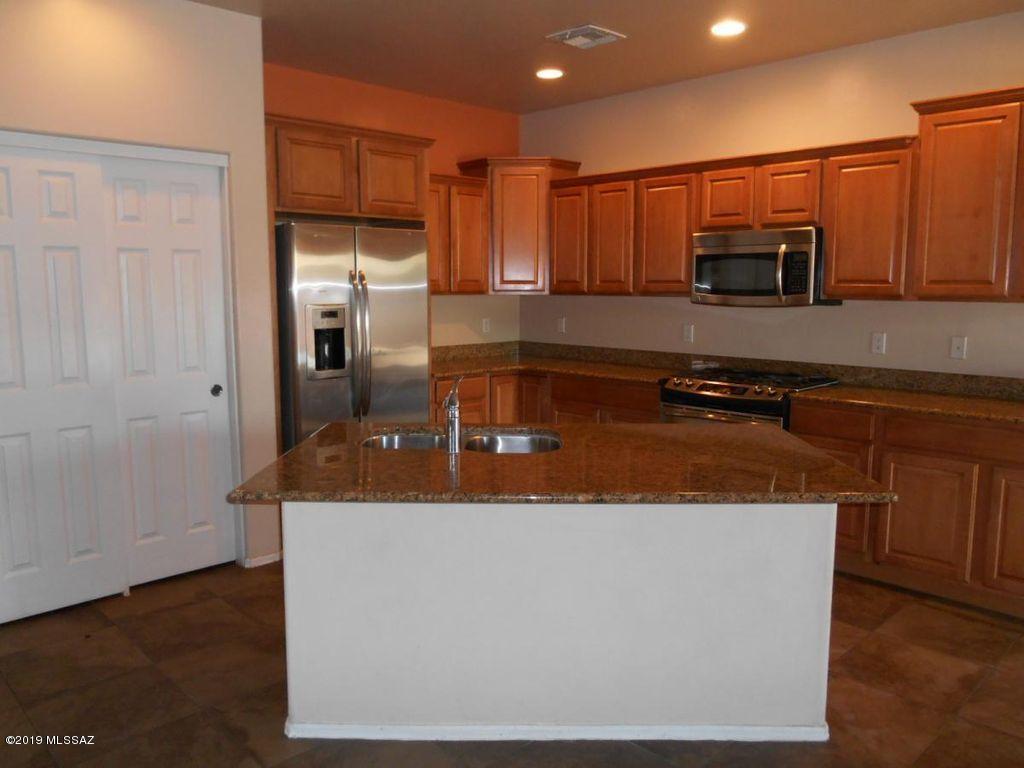 Sierra Morado - 4 Bedroom, 3 bath, 2 story home on corner lot. Great room is open to kitchen and dining room with ceramic tile flooring. Kitchen features Corian counter tops, all stainless steel applances with gas stove and m/w, breakfast bar island and pantry. Bedroom 4 is located downstairs with wood laminate flooring and full bath. Upstairs features a small loft, 3 bedrooms, laundry room with w/d hook ups. Bedrooms are carpeted. Master bathroom includes walk in shower, double sinks and a walk in closet. Home has extra storage area, A/C, 2 car garage and fenced back yard with covered patio. Community includes community pool, basketball court, park and walking trails.