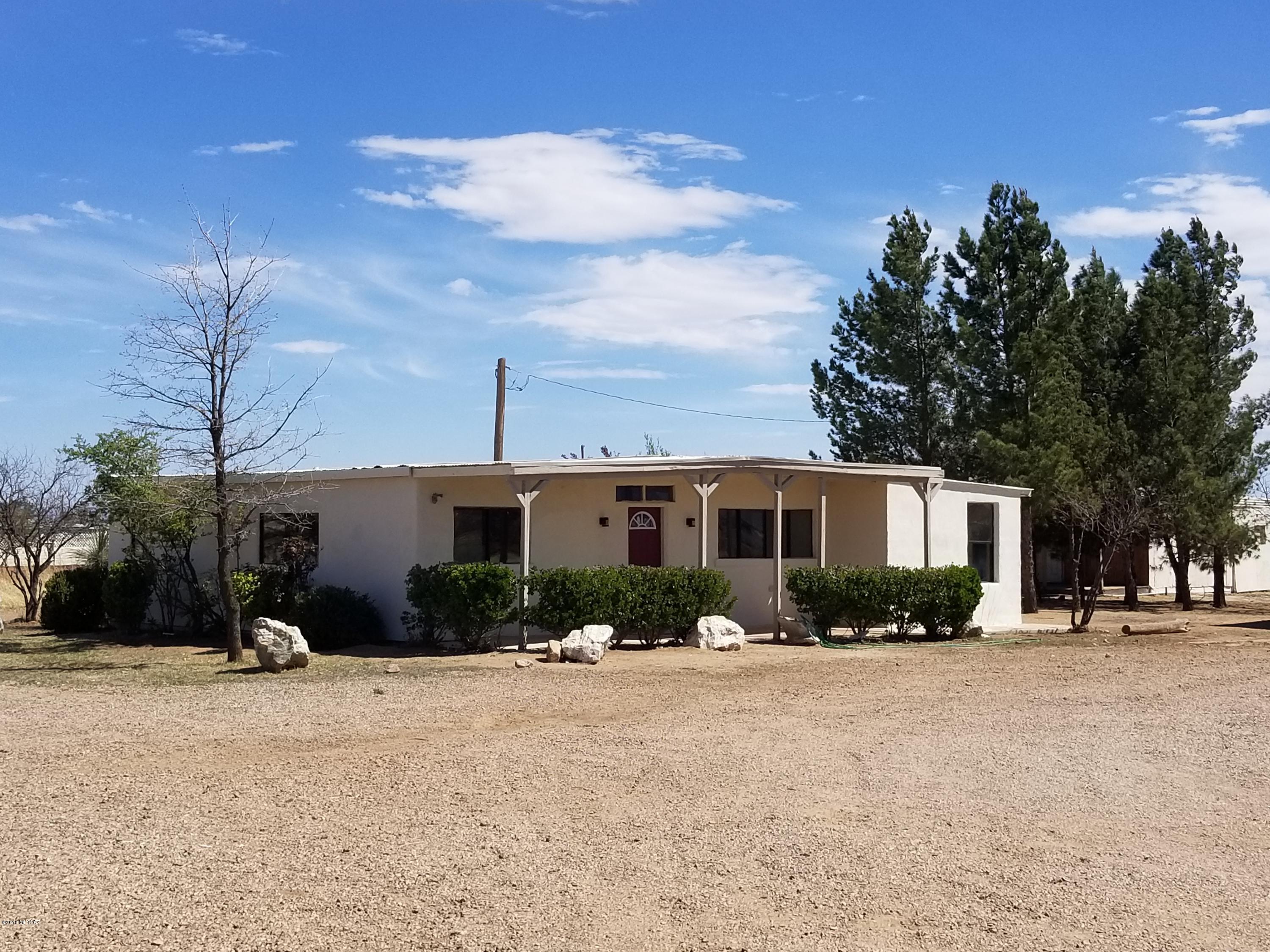 Nice starter home with a lot of character.  Has fresh paint inside and out. New bathroom in second bedroom.  New countertops and backsplash in the kitchen.  New laminate wood flooring. Beautiful wood accents throughout and ceiling is gorgeous.  Has some neat features like the pocket door and double bedroom doors for the master bedroom. Room for your animals or toys.  Additional storage building with a covered porch. Carport on the backside of the storage building.
