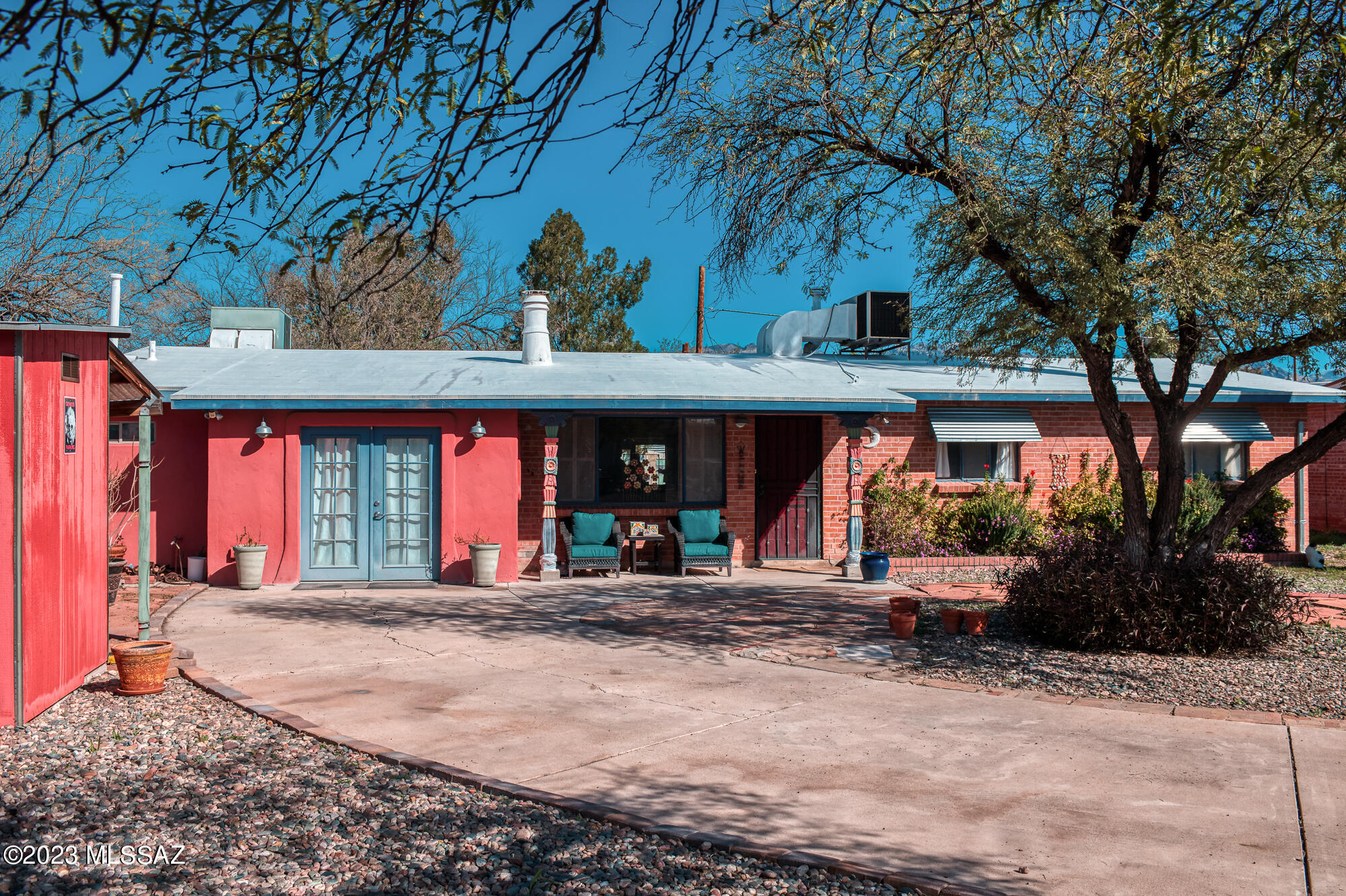 Located next to the Tucson Botanical Gardens this charming, eclectic, and unique midtown home offers 3 bedrooms and 3 full bathrooms. The main living area features a gorgeous fireplace, access to the Arizona room, and gives the home a split floor plan with each wing offering its own primary bedroom option. Living room walls feature material acquired from the Tucson Opera House and perfectly accentuates the bold curves leading to the kitchen. Expansive laundry room sits off the Arizona room which brings in natural light. As you walk out back you will be greeted by a gorgeous water feature with gas fire pit planters on either side which divides the yard in two. The larger section features shade posts, fruit trees and areas for gardening, with the option to have a dog run or chicken coop.