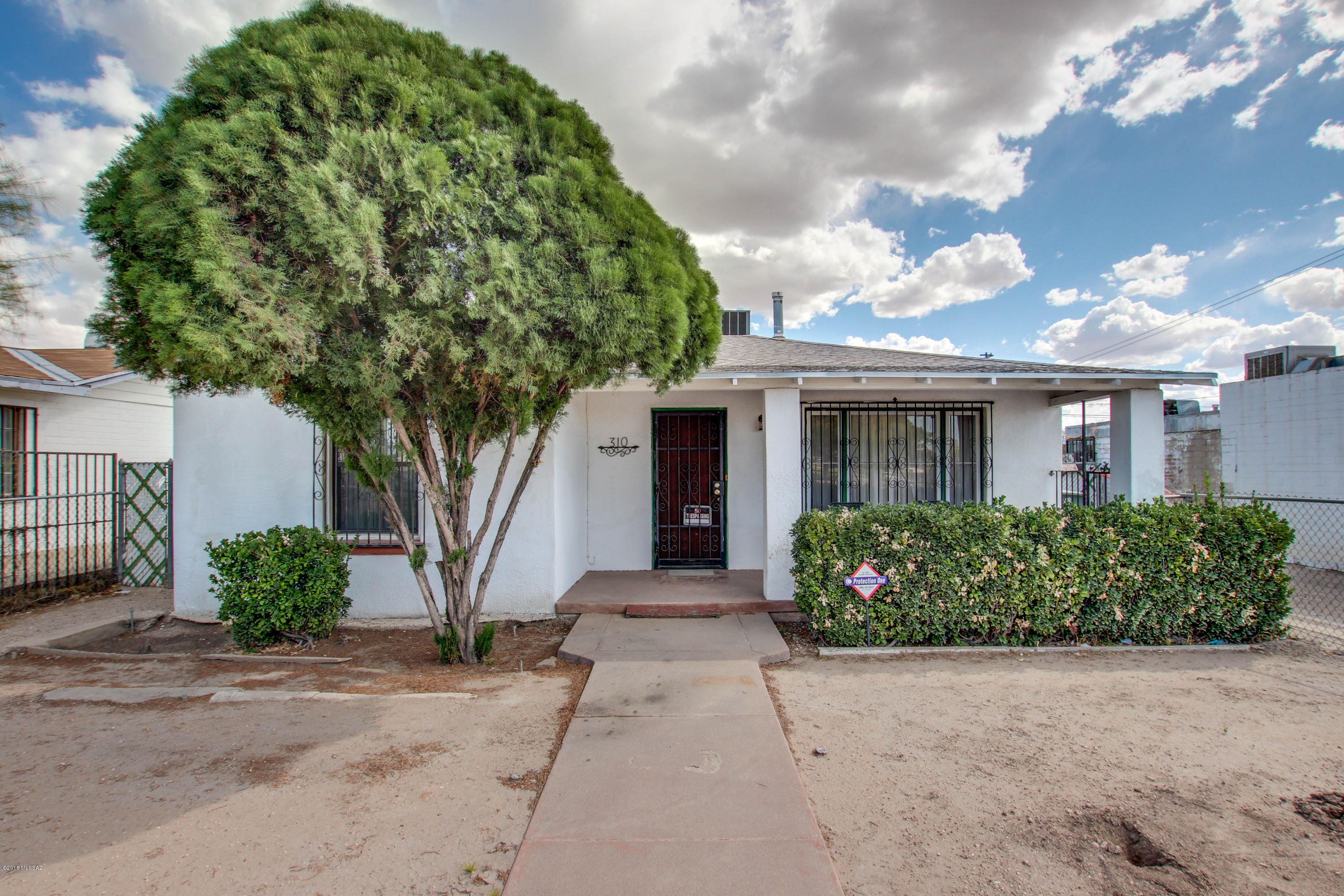 Wonderful and well maintained home. Zoned C-1, can be also be used for office or business. Open floor plan, tile throughout and newer AC.  Huge fenced in backyard with detached 500 square ft. garage and covered storage/workshop area. Plenty of parking with better access from the alley. Close to downtown with easy and I-10 & I-19. Great potential. Come take a look.