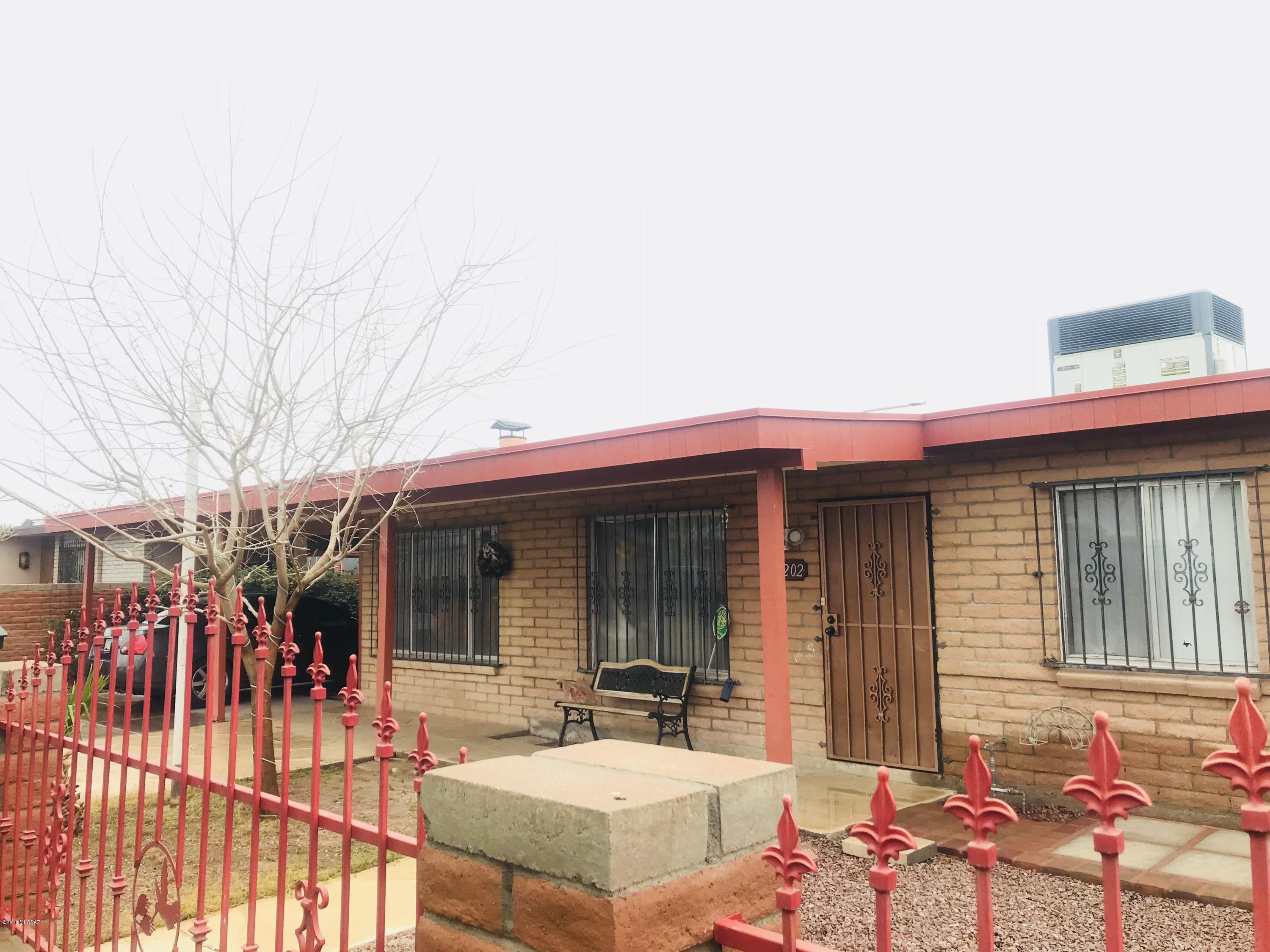 unique brick home, separate family room with fireplace, ceramic tile, security wrough iron throught out, big back yard with covered patio. Frutal trees