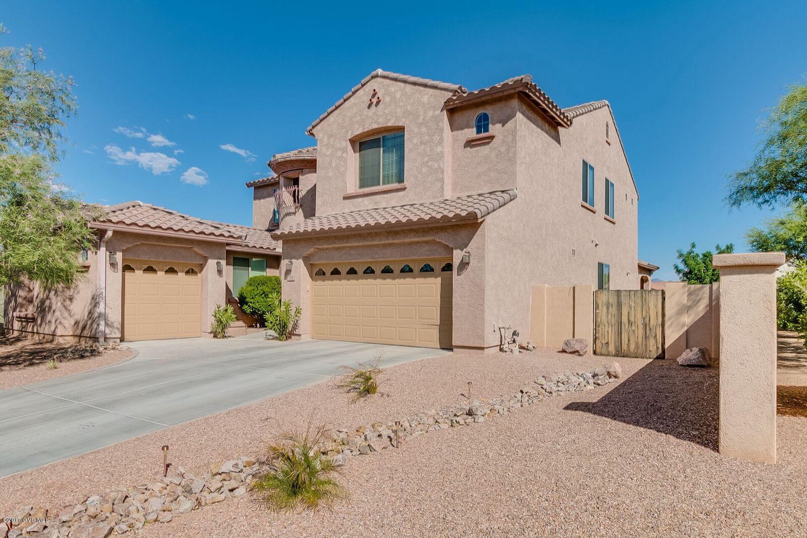 Exceptional 3624 sq ft LUXURY home located in the gated Entrada Bonita subdivision of Rancho Sahuarita. Loaded w/ upgrades and high end finishes; Wood-look tile flooring, custom deco tile designs, gas fireplace, butler's pantry/serving area w/ granite, wood and iron stair rails, and soaring ceilings. Premium corner lot backs to a small park, w/ no homes behind. Immaculate Stafford model w/ 5 bedrooms and a loft. The first floor has a great in-law suite, gorgeous chef's kitchen w/ granite counter tops, undermount sink, huge island, 42'' upper cabinets w/ crown molding, upgraded stainless steel appliances w/ gas range & vented hood. Private backyard features an extended covered patio, artificial grass, and professional landscaping. Walking distance to the AWARD WINNING Anza Trail K-8 sch