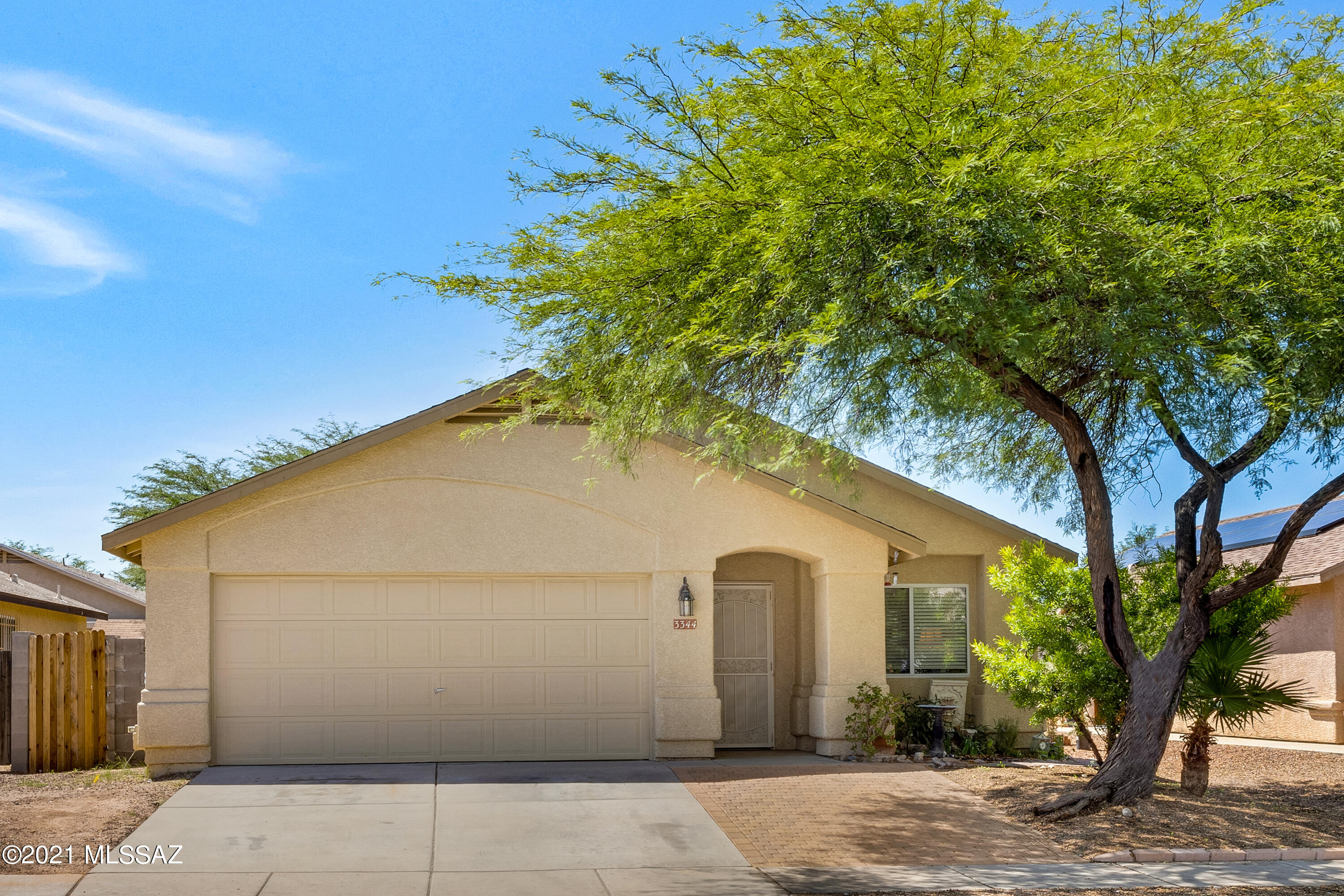Welcome to your new 3 bedroom 2 bathroom home located in the Wilmot Vista community in the city of Tucson! Pulling up to the home you are greeted by a spacious 2 car garage, desert landscaping and mature trees. This home has solar that replaces TEP bills with a fixed cost.  Stepping into the home you will be welcomed by a spacious floor plan that includes neutral-toned paint, tile and hardwood flooring throughout, high vaulted ceilings, and a large family room and great room allowing you plenty of room for all your friends and family gatherings. Your eat-in kitchen showcases ample cabinet space, a large pantry, a breakfast bar, stainless steel appliances, granite countertops,  gas range, and plenty of space for preparing home cooked meals. You will be delighted with the bedrooms in the home as they each provide generously sized closet space and are vast in size. Your primary bedroom provides a large walk-in closet with built-in shelving, a full en-suite bathroom with separate tub and shower, hardwood flooring, and a spacious and cozy layout to end your day in. Step outside to your backyard that features a paved patio, mature trees, grass lawn, and plenty of space for all your favorite outdoor activities. Your new community also provides you a total of 3 parking spaces for you and your guests! You will appreciate the short drive to all your new favorite places such as the Desert Square shopping center, multiple community parks, Fred Enke golf course, Park Place shopping mall, endless amounts of restaurants, grocery stores, convenience stores, and easy access to the I-10 freeway as well as Davis Monthan Air Force Base and Amazon distribution center! You don't want to miss out on this great opportunity to call this home your very own! Schedule your showings today!