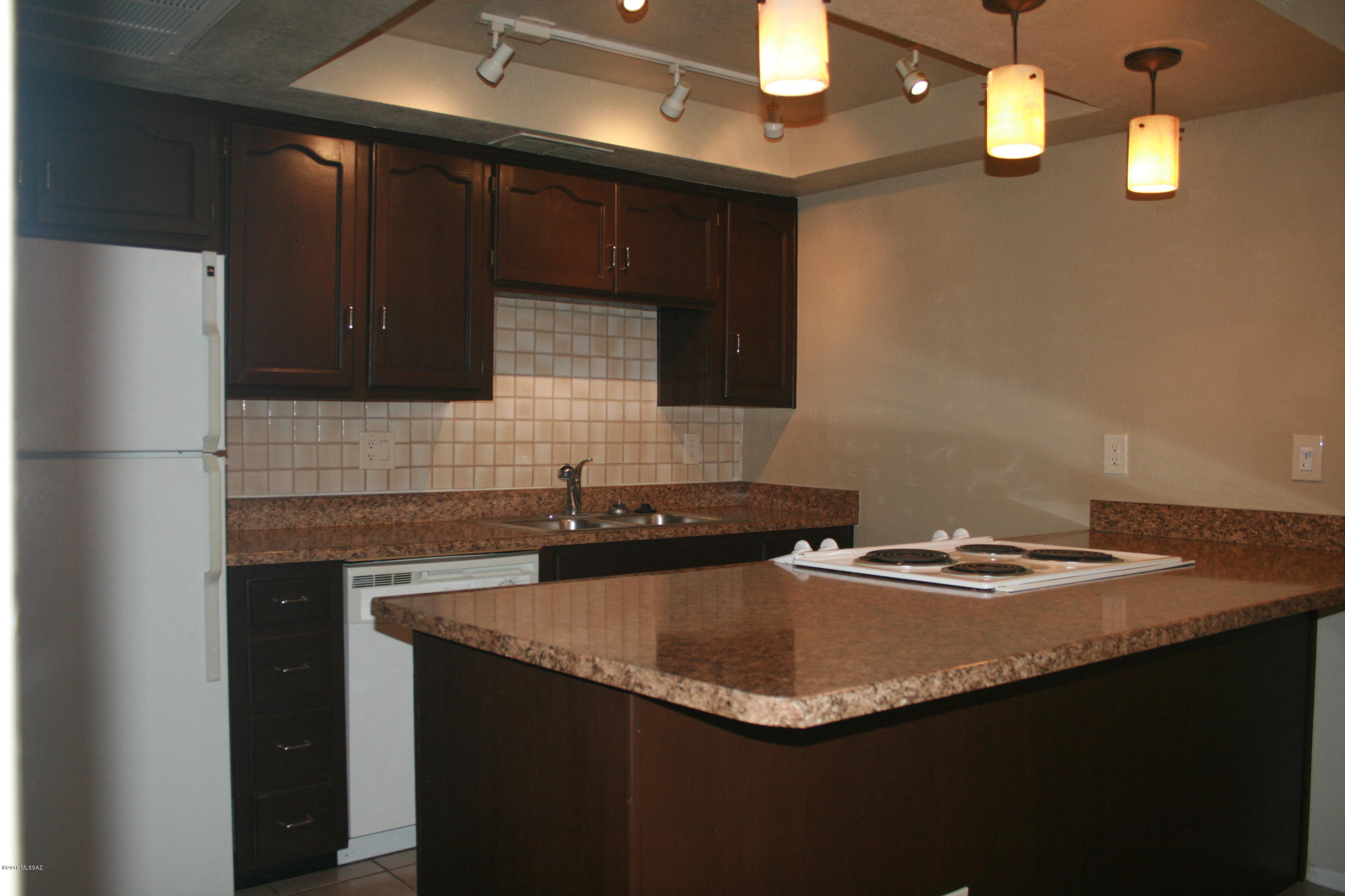 This beautifully maintained move-in ready condo is ready for occupancy. Fantastic location, close to UA, Banner Medical Center, farmer's markets, food and entertainment, and Tucson's LOOP used for cycling, running, and walking with easy access from your front door. Unit features a great room with vaulted ceiling, split bedroom floor plan and a full bathroom. Home owner association fees cover pool, spa,landscaping, external maintenance, recreation center, water, sewer, and trash. One covered parking space is also included.