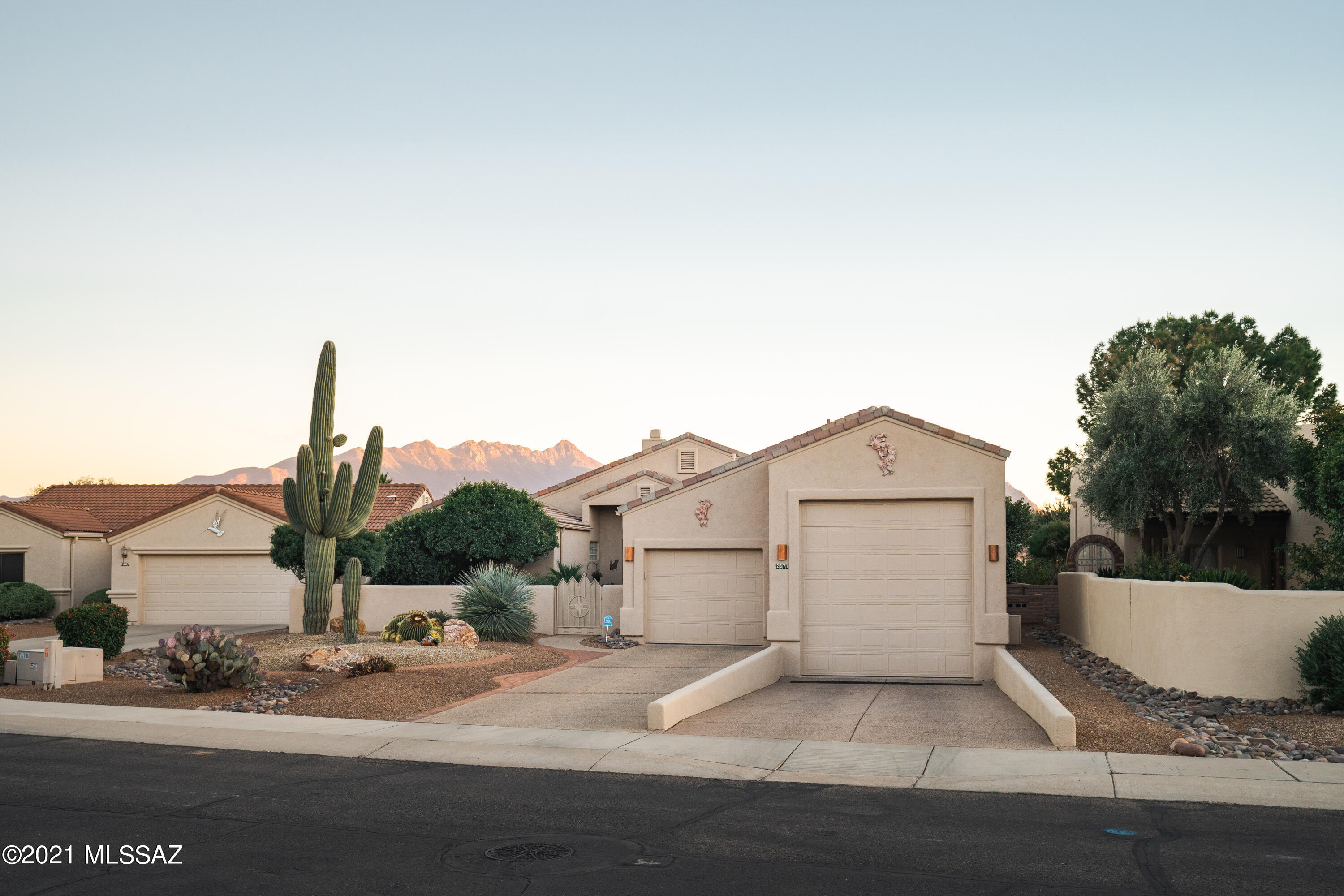 Incredible find in the links gated community!  Custom-built DORN home w/47'long RV Garage w/ 30 amp, 50 amp w/sewage drain, or workshop w/lots of storage cabinets w/ custom service door to courtyard w/wrought iron security door. Granite countertops in both baths & kitchen. Kitchen features SS Appliances, Electric range, double undermounted sink w/RO.  Laundry room plus den w patio door, plus office. Gas fireplace, surround sound inside & out, plantation shutters, front courtyard Huge back patio w/gorgeous mountain views. Custom wrought iron security door for entry. Recessed canned lights in main living area, office, kitchen. Dual Pane windows throughout with custom modern windows in living room that gives access to the beautiful mountain views.  Water softener, tandem garage,10' Saguaro. 2 minutes from the highway, seconds away from the Torres Blancas Golf Course, close to shopping malls, gyms, and restaurants. Owners spared no expense meticulously maintaining this beautiful home, it is a must see and it will not last long! Furnishings are negotiable with a separate bill of sale.
