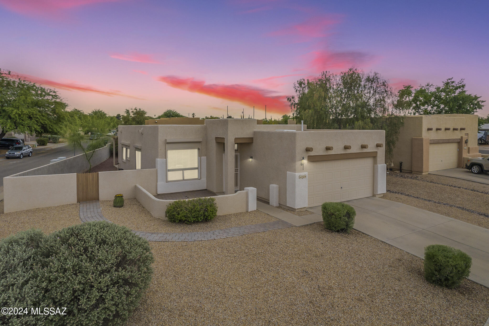 Move into this desirable East Tucson neighborhood. This beautiful Canoa built Santa Fe style home is on a premium corner lot with mountain views. Enjoy your morning coffee while taking in the stunning mountain vistas from the comfort of your front courtyard. The picturesque views provide a tranquil backdrop to your daily life. There are large picture windows that provide ample natural lighting that highlights the warm earthy tones of the wood flooring and tile. The owner was meticulous in maintaining the home and added new flooring in the bathrooms and bedrooms, new fixtures and toilets, as well as fresh paint. There is enhanced security and peace of mind with remote-controlled rolling shutters on all windows and the slider, offering protection from the elements and added privacy. Sonoran Meadows is a charming community with only 22 homes on oversized lots. Conveniently located near Davis Monthan Airforce Base, shopping, parks, and schools. These homes rarely go for sale. This charming home is move in ready and won't last long.