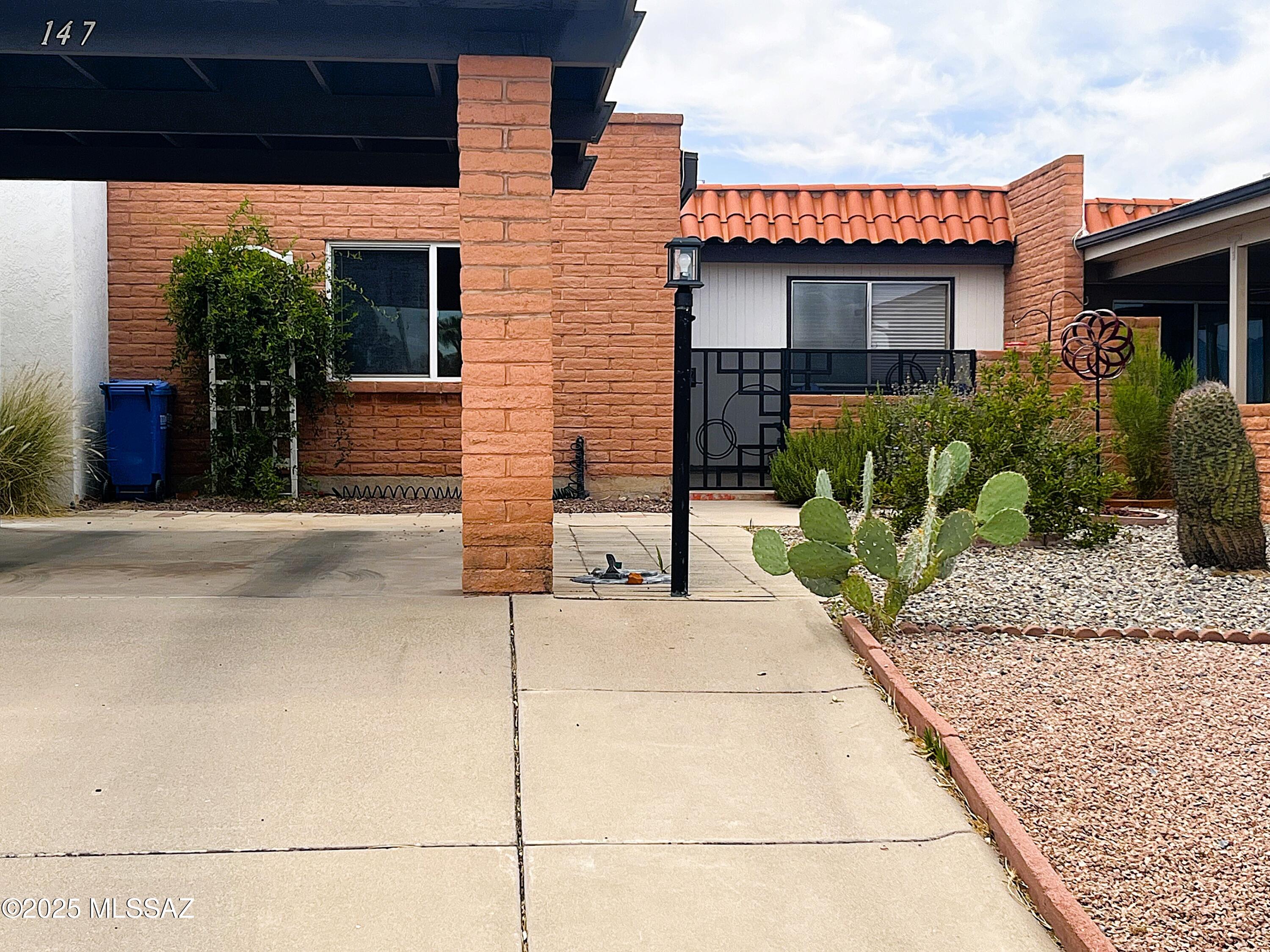 Experience a serene living style in this lovely 2-bedroom, 2-bathroom Townhome, complete with Mountain views and a 1-car carport. Enter through the cute courtyard with modern wrought iron fencing and gate. Light and bright floor plan with Ceramic tile flooring throughout. The kitchen space offers a newer stove (2024), refrigerator (2023), and a good-sized pantry. To top it off, the water heater was upgraded in 2024, and it also boasts a brand-new washer/dryer installed in 2025. The HVAC system, updated in 2019, is under a maintenance plan ensuring a comfortable and serene atmosphere year-round. The owner's suite comes equipped with dual closets and an in-suite bathroom featuring a walk-in shower. The guest bedroom also comes with a sizable closet, and the guest bathroom features a shower and tub combination.  Escape to the backyard, a peaceful retreat with pavers and charming landscaping. The Green Valley recreation membership promises endless fun and entertainment. The location is unbeatable, just a short distance from the pool and shuffleboards, offering easy access to a variety of shopping and dining amenities, as well as the I-19 freeway, making convenience a part of your daily life. In addition, guest parking is available just in front of the townhome. Immerse yourself in the vibrant lifestyle of the age-restricted Green Valley community (55+), where inspiration and tranquility meet.