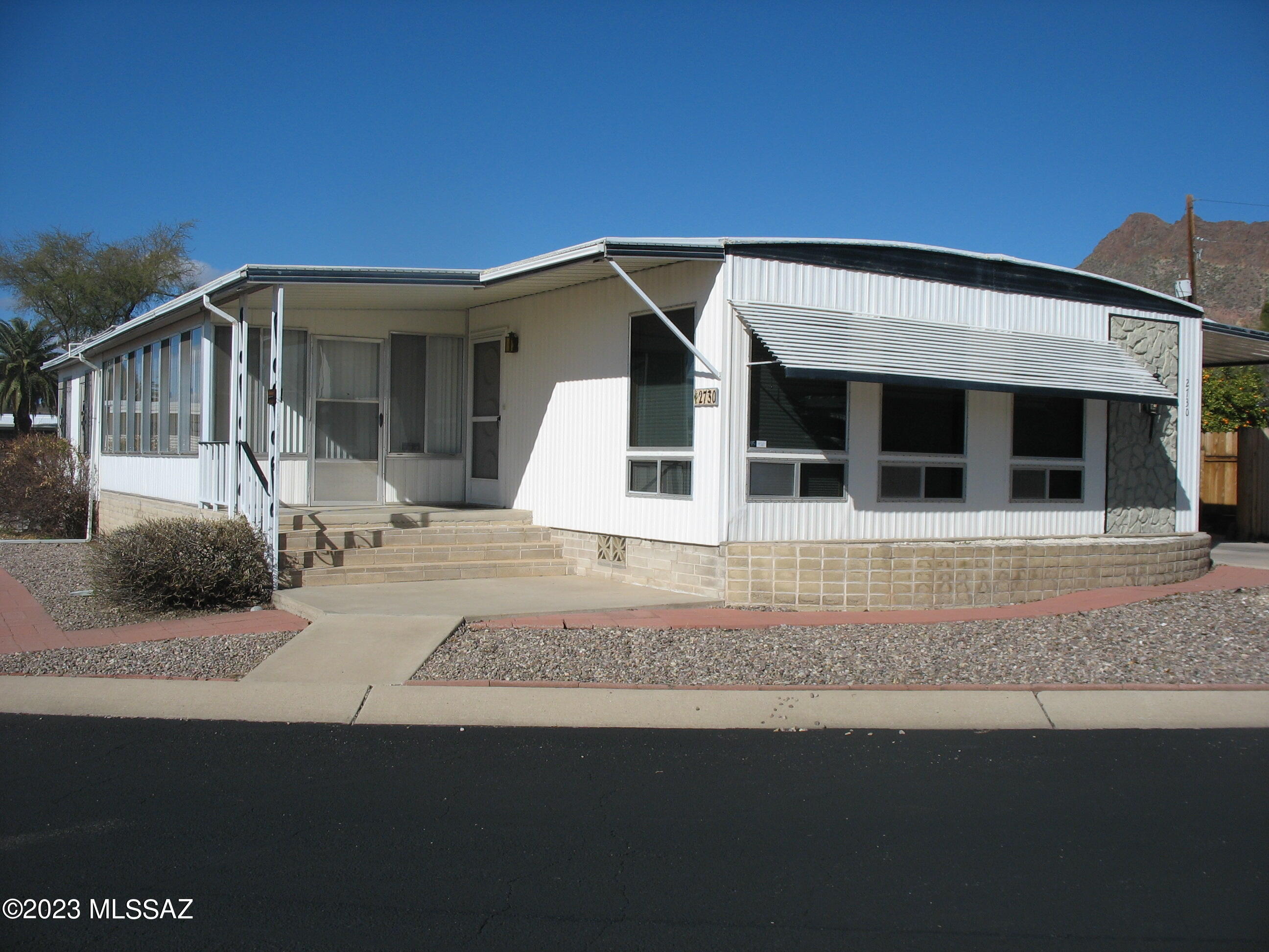 Large corner lot in desireable part of this 55+ community. Large living room with large windows and great mountain views. Light and bright south facing AZ room. Updated kitchen with newer oak cabinets. Extra large master bedroom suite including an extended open space. Very well maintained home. The HOA fee includes unlimited golf, tennis, pickle ball, shuffleboard, pools, spa, exercise room, trash collection, and much more. You own the land!
