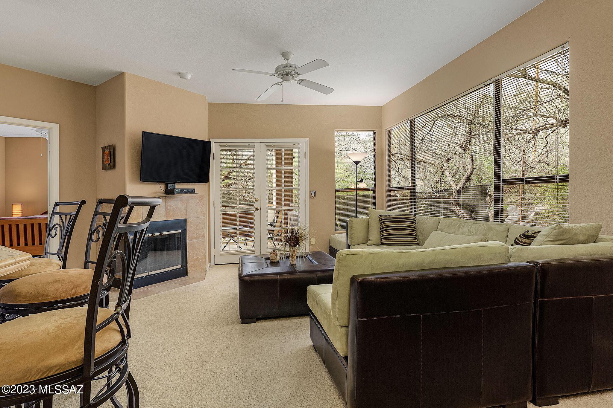 Your new condo nestled in Ventana Canyon foothills is here! Light & bright floor plan has 2 split bedrooms for extra privacy, 2 full bathrooms, a nice-sized den ideal for an office, & perfectly flowing open common areas. Tile flooring in all wet areas, soft carpet throughout, cozy fireplace, & French doors leading to the covered back patio are features worth mentioning. The beautiful kitchen showcases tile counters & backsplash, wood cabinets, built-in matching appliances, & a breakfast bar. Romantic main retreat has double doors entrance, private patio access, & a bathroom w/mirrored closet & makeup area in the sink vanity. Enjoy the community & mountain views while sitting under the secluded covered patio. Amenities are pool, clubhouse, gym, etc. Take advantage of this awesome property!