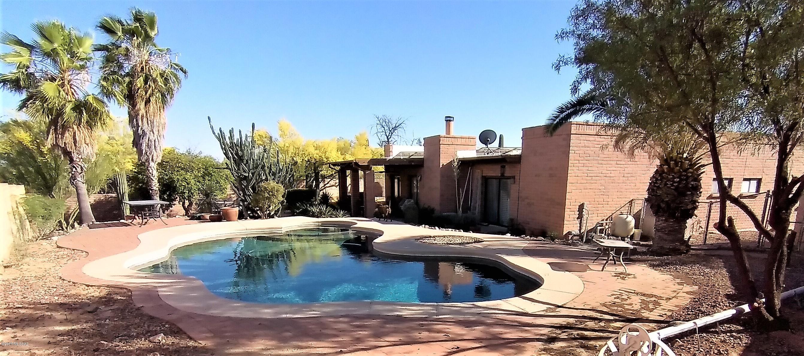 Come get a great deal on this home with a backyard oasis! Home includes pool/spa on large corner lot near golf, restaurants & shopping. This great located slump-block home features a spacious living area, roomy kitchen w/ breakfast nook, formal dining, 3rd bedroom perfect for office, skylights, solar, and front entry courtyard. Home's rear patio opens to a nicely landscaped pool/spa and yard. Plantation shutters T/O and an over sized garage with room for RV parking or a large shop follow the fence line on the outside of north wall, this home will not last long at this price! GO SEE BEFORE IT'S GONE!
