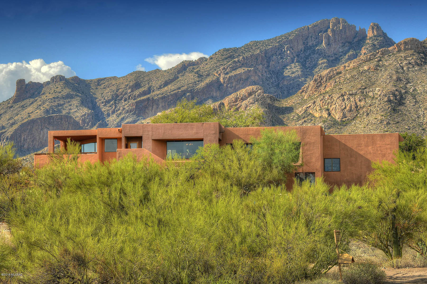 Stunning Hilltop contemporary Foothills home with Spectacular City, Mountain & Sunset views. This gorgeous home sits on .83 acres, offering 4 bedrooms, an office den, and a workshop/darkroom. Desirable split floor plan w/ 3 additional bedrooms, open-concept kitchen and dining area, abundant cabinets, new SS Kitchenaid Appliances with a huge granite island. Large porcelain tile in the living and dining areas, and new carpet in the bedrooms and office. THIS ONE IS AN ABSOLUTE MUST SEE!! OWNER/AGENT