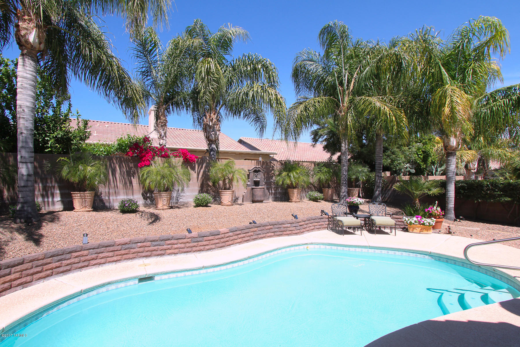 Pride of ownership & location! Why buy new when you can have this highly upgraded 4bd, 2ba, 3car gar. Notice the engineered hand scraped hardwood floors, elegant plantation shutters. Ceilings w/ crown molding and upgraded baseboards. In the kitchen, you will notice the  upgraded SS appliances, GE 5 burner gas range, GE dishwaher & GE convection microwave oven, LG refrigerator and a wine cooler! Silestone counter tops & intricate back splash. Enjoy the sparkling pool & immaculate landscaped backyard. Too many upgrades to list come see for yourself, you won't be disappointed. Enjoy the clean energy and lower monthly payments with the leased solar panels. Seller has all the information you need on the solar, it is a very easy process.