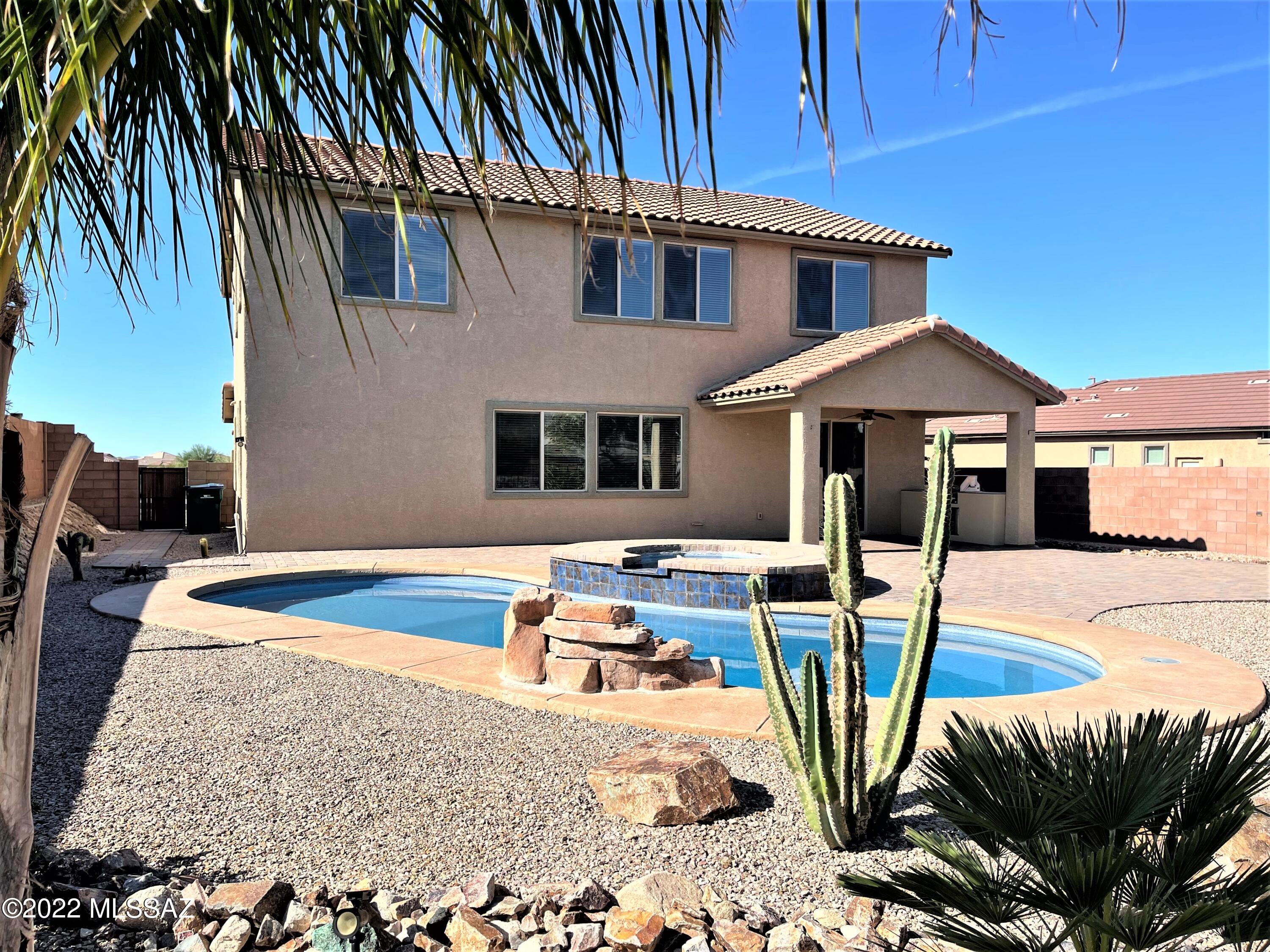 Surrounded by mountain views, You'll love this immaculate large 4 bedroom home, 1 on the main floor, plus 3 full baths. Split bedroom plan w/spacious loft. Sprawling great room & kitchen overlooks backyard with pool, spa and easy care desert plantings. Custom painted interior. Other highlights: in ceiling surround sound speaker system in great room, master & rear patio, wainscoting & floor-to-ceiling columns in dining room, kitchen w/granite countertops & glass tile backsplash + additional cabinets over kitchen desk area. Large laundry room has abundant storage, deep utility sink & much counter space. Additional features include: ceiling fans throughout home, 3 bay tandem garage, Nuvo water softener, in-home fire/sprinkler system. Fully landscaped, easy care front & back yards w/expansive paver patio/path wrapping to the front yard & driveway. Large refreshing salt water pool w/waterfall feature & spa w/surrounding seating area & spillover, built-in gas BBQ & large built-in gas fire pit w/bench. The oasis style backyard is a sanctuary, peaceful + a great space for entertaining year around. Close access to the community park- nice quiet neighborhood. Call for an appointment to view this lovely home.