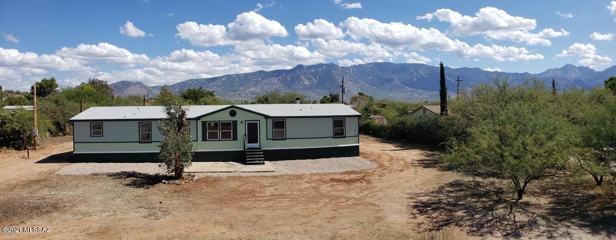 AMAZING VIEWS! Pride of ownership abounds in this well-maintained, 2001-built home on a 1/2 acre, East-facing, lot with unobstructed views of the Catalina mountains! The over-sized island kitchen has an abundance of cherry cabinets, upgraded appliances, and lots of counter space. The massive living room has plenty of space for large holiday gatherings and you can spend cool evenings relaxing around the impressive cherry fireplace. You'll LOVE the vaulted ceilings, fresh paint, new flooring, lights, faucets, and fixtures. The HUGE 5th bedroom is perfect for home office, home school, business, or aging parents and there's a circle drive with plenty of parking and a separate power pole for RV hookup. Few properties offer the versatility and amenities of this home. This is truly a RARE GEM!