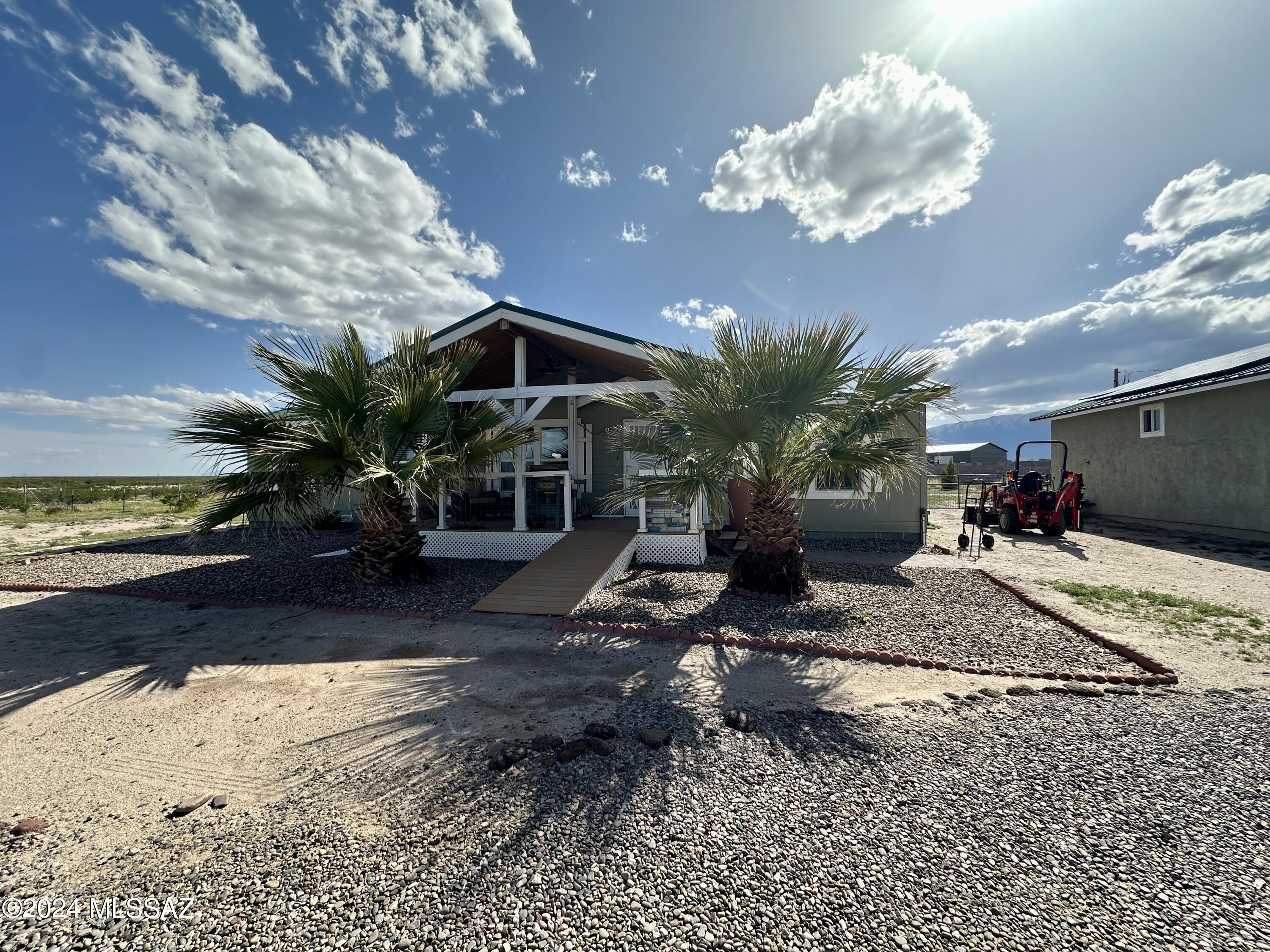 This sensational property is ready for it's new owner! Two and a half acres at the end of the road with BLM on the entire east property line. Sit on the covered front porch and watch those beautiful Arizona sunsets. The front of the property is nicely landscaped, and the backyard is fenced. The home has been well maintained and boasts a new metal roof as does the detached oversized garage. There is plenty of space for all your toys and an electrical hook-up for your RV.