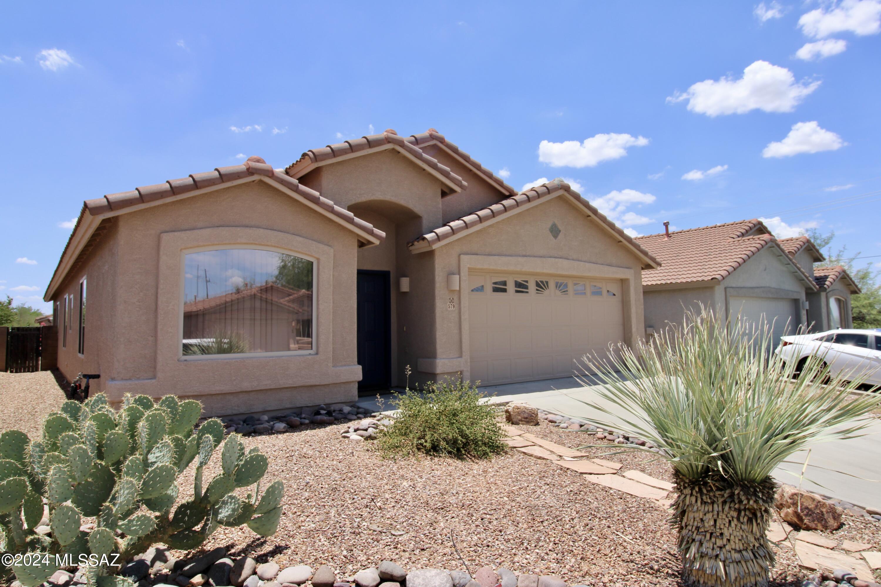 1,873 SQ. FT. 4 bedroom/2 bathroom home. Thoughtful single-story floor plan. Impeccably maintained with porcelain tile throughout and new carpet in bedrooms, newly painted interiors. Spacious open floor plan, great for entertaining! Large living room, large separate family room opens to the kitchen with a large island. Blinds and ceiling fans throughout! Spacious bedrooms! Utility room with washer + dryer included! 2 car garage! Spacious, fully fenced back yard. Professionally landscaped front yard has incredible curb appeal. Convenient Tucson location; close to groceries, hospitals, walking trails and more!