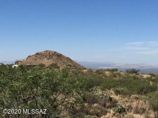 Seller is VERY motivated!!!! Bring ANY and ALL offers. UNBELIEVABLE mountain AND city views. One of the few spots to build nestled against the Santa Rita Mountains. Backs up to state land. Property is a nature lovers dream with abundant vegetation and wild life. Let the beautiful stars light up the night sky.  This is an incredible property during the Monsoon season with a musical water fall. Come build your custom home and enjoy the quite life yet easy access to I-10, Raytheon, Davis-Monthan Air Force Base, shopping,  downtown, etc. Award winning Vail School District. Drill a well or install a holding tank for hauled water or a possible coop share.