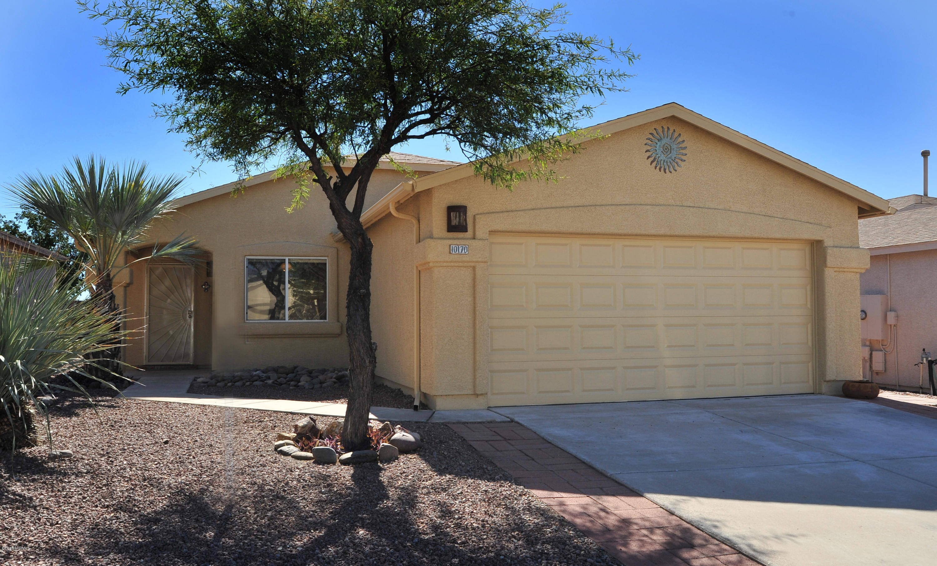 Excellent opportunity for move in ready, clean three bedroom, two bath 1,385 SqFt with spacious great room, contemporary in enticing East side location. Enjoy mountain views, desirable N/S orientation with private, pristine quiet landscaped backyard, desert views (w/no homes or loud busy streets behind) complete with:fresh paint, long covered patio with custom tile and blinds, mature mesquite, flagstone, colored concrete hot tub pad and green, no maintenance artificial grass. Upgrades inside include: tile with carpet (2014) in bedrooms, recent AC (2013), dishwasher (2014), garbage disposal (2014), custom designer bathroom sink, ceiling fans, double pane windows, security door, laundry room, and attached garage with extra storage cabinets. All appliances convey, come see for yourself today.