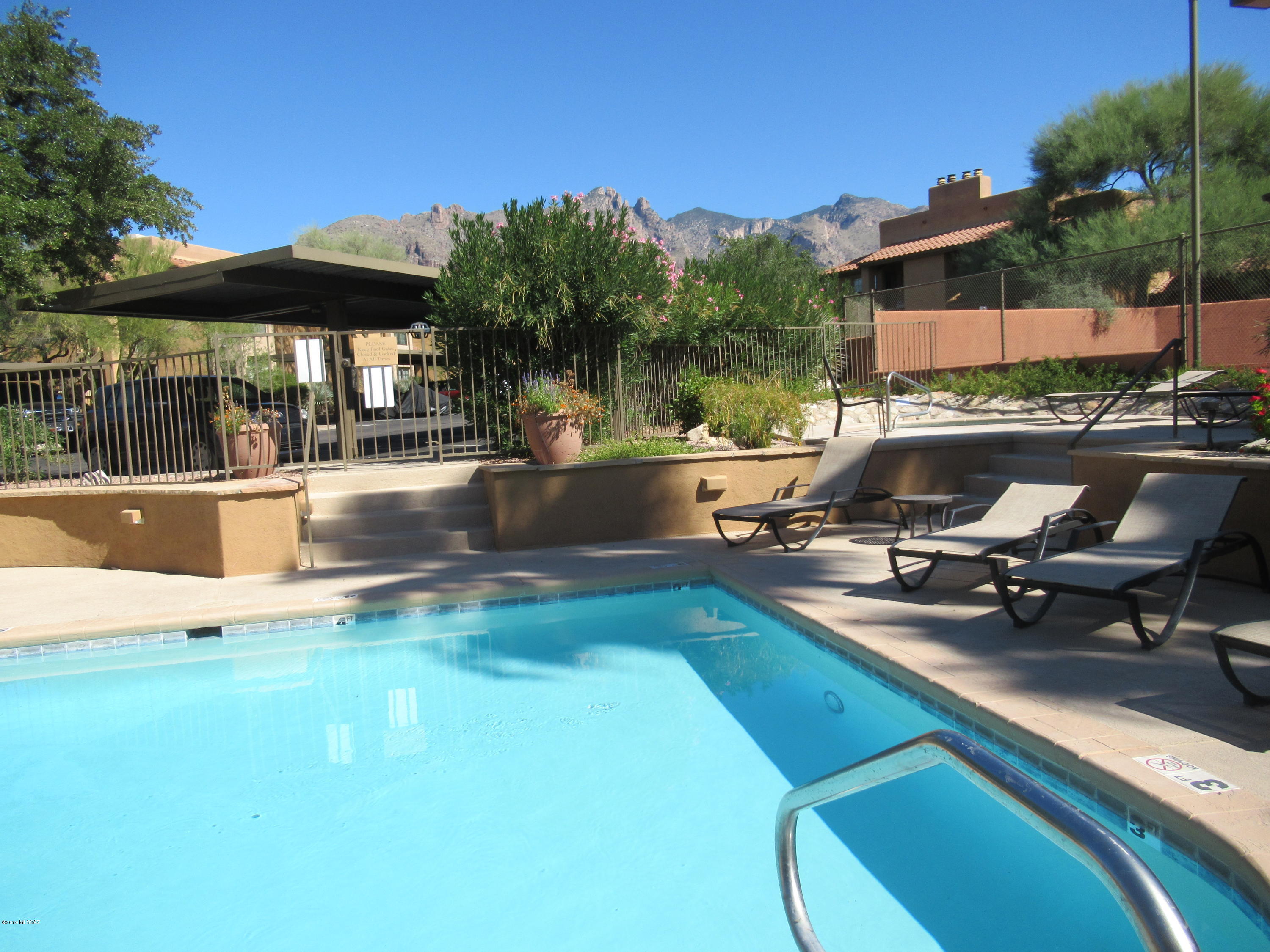 AVAILABLE NOW.  Stylishly fully furnished condo in the Catalina Foothills. Updated ground floor corner unit with 2 bedrooms and 2 bathrooms. Fully equipped kitchen with granite counters and stainless steel appliances. Wood burning fireplace in living area.Two TV's - one in living area and 2nd in Primary Bedroom. Hi-speed internet. Washer and dryer conveniently located in condo included. City, mountain and sunset views from covered back patio.l Community includes, pool, spa, tennis, community room and fitness room. Located adjacent to upscale shopping center, restaurants, banks, etc. Pricing depends on season and length of rental. Contact listing agent for more information. Pricing varies by season and length of rental.  P460
