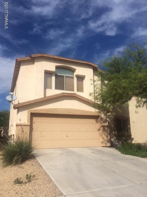 Spacious 4 bedroom, 2 1/2 bath home in Sonoran Ranch Villages. 2 story home features tile & carpet throughout, 1 bedroom and 1/2 bath downstairs. Cozy fireplace in living area, open kitchen concept with all appliances and large kitchen pantry. Second floor features 3 bedrooms 2 full baths and HUGE loft. Oversized covered patio and BBQ area great for entertaining in the large walled back yard. Near Tucsons Famous Casino Del Sol Resort and Amphitheater! Priced to sell quick!!