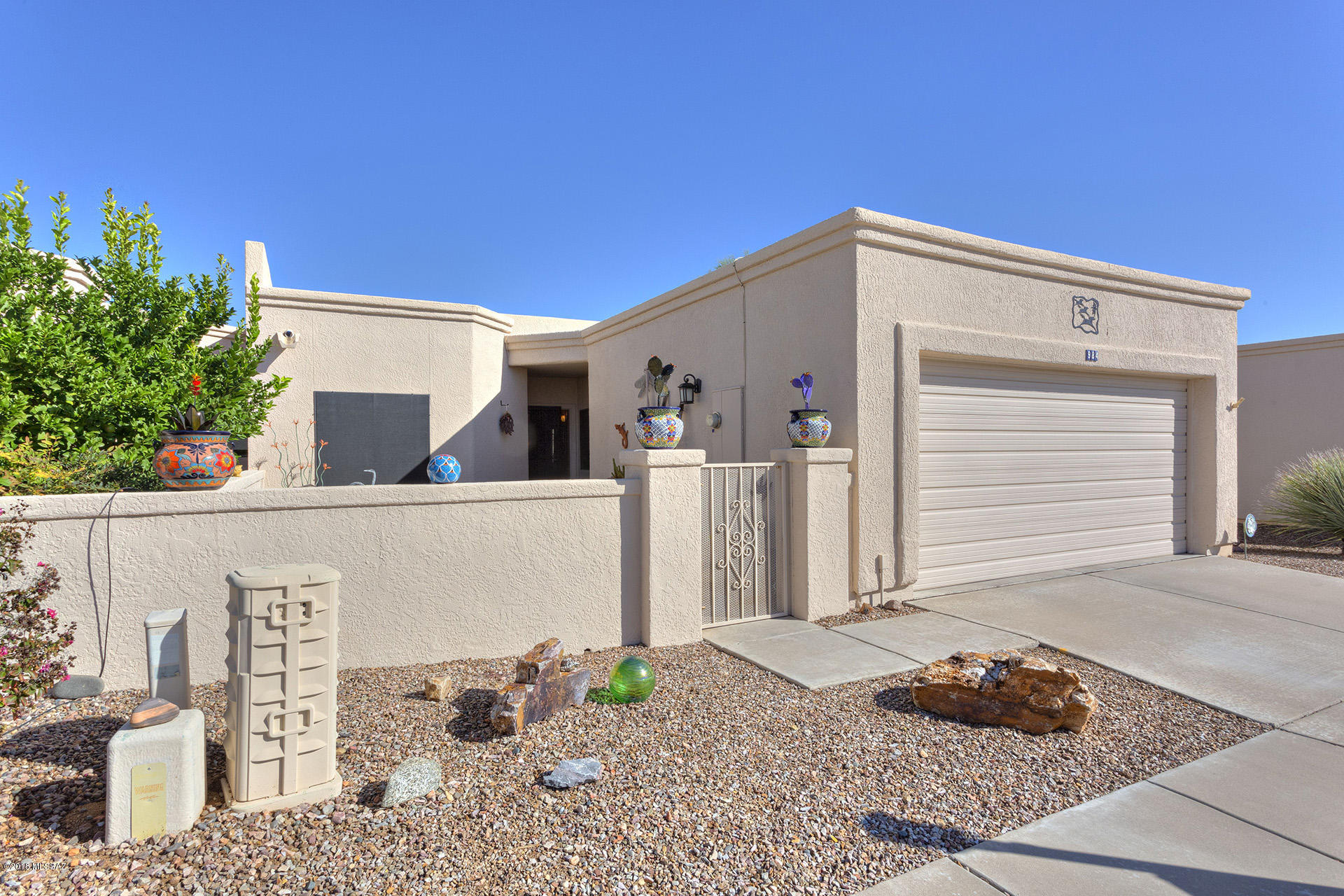 An ''oasis in the desert'' is the best way to describe this beautiful townhouse. From the moment you pass thru the courtyard, you will be impressed by the pride of ownership.  Centrally located in the much desired Madera Vista, this 2 BR 2 BA townhouse has the vaulted ceilings and clerestory windows that are so typical of Dorn construction.  A Georgetown model it is further enhanced by the beautiful kitchen totally updated in 2017, tile floors throughout, wooden shades and shutters, fireplace in great room, den area, solar screens on all windows, security doors, and private wrap-around patio available from great room and master bedroom.  The arroyo in back of property with an endless variety of wildlife and birds is accessible from the side of the patio.  This home is move-in ready. Please put it on your must-see list.  You will not be disappointed.