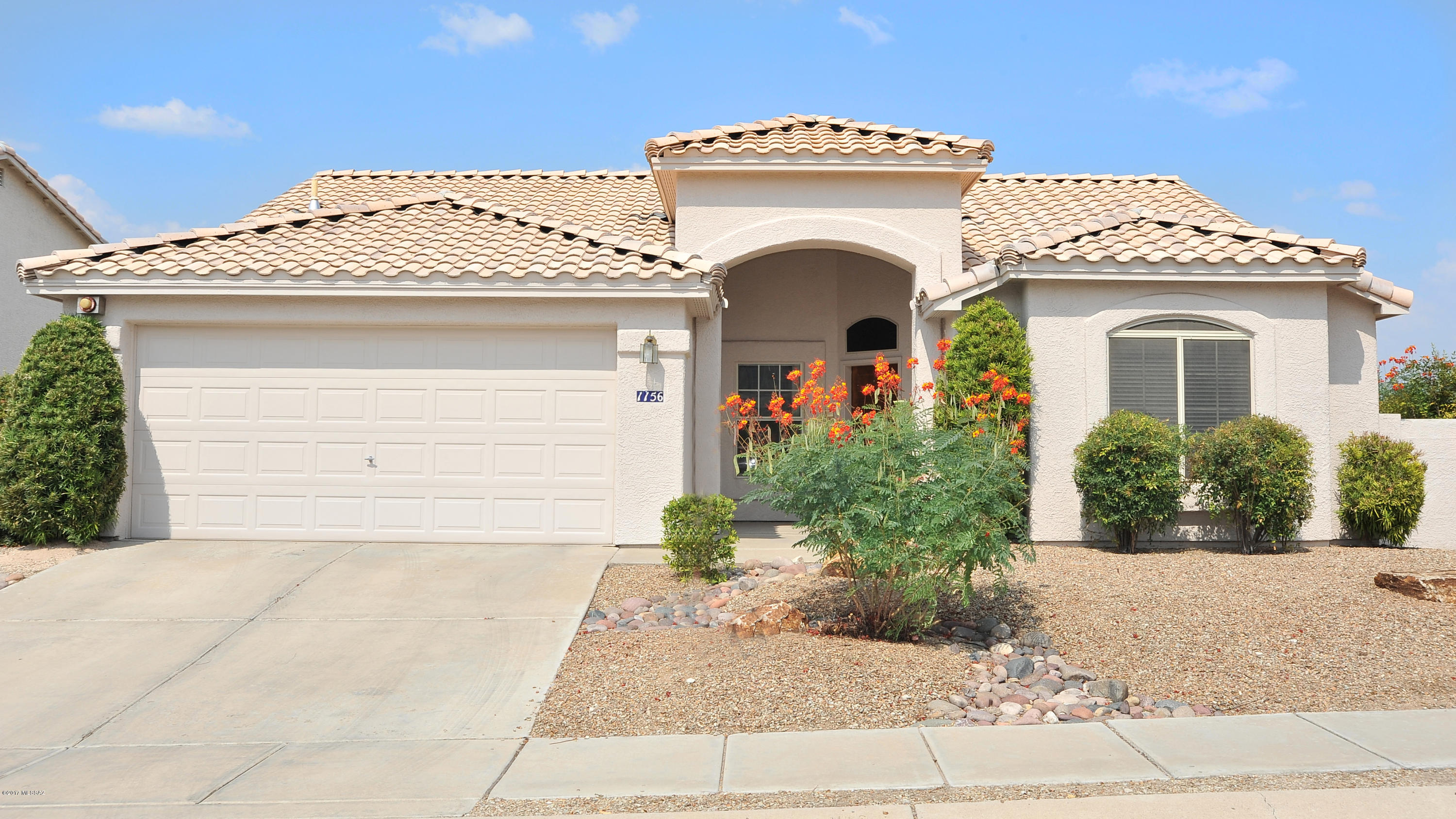 Original owners have immaculately maintained this spacious 4 bedroom 2 full bath and will accept or counter offers $235,000-$249,000! Secluded view lot looks out onto the Catalinas & a protected nous upon which nothing can ever be built! Inside you’ll find brand new plush earth tone carpet accented by neutral tile, spacious bedrooms, a cozy family room w/ a wood burning fireplace and soaring ceilings. $17,000 roof is approximately 1 year new! Built-ins in garage, intercom, wired for security.
