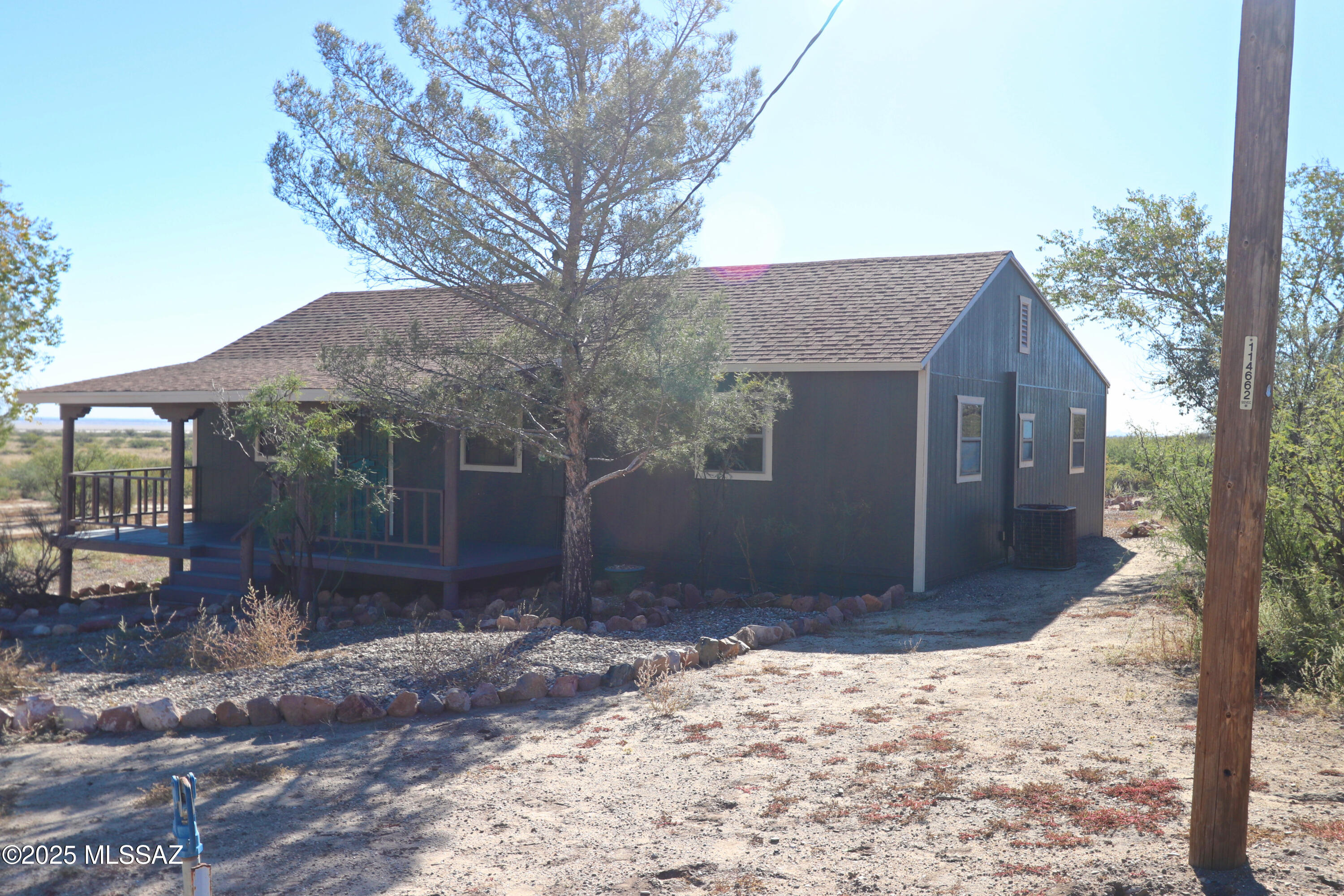 Rural living in Southeast AZ. Two Bedroom two Bath house on more than 1 ½ acres. New paint inside and out. New flooring. New Kitchen stainless steel sink.   Easy access to I-10. Ceramic tile and laminate flooring.  Ceiling beams. Front and back covered porches. Back porch is screened. Shop building. Garage. Trees. Mountain views. Willcox is a 20 minute drive which offers shopping, healthcare, RV parks, movie theater, museums,  restaurants and wine tasting. Mild climate, good schools.  SELLER WILL CONSIDER  BUYER COSTS ASSISTANCE FOR RGHT OFFER.