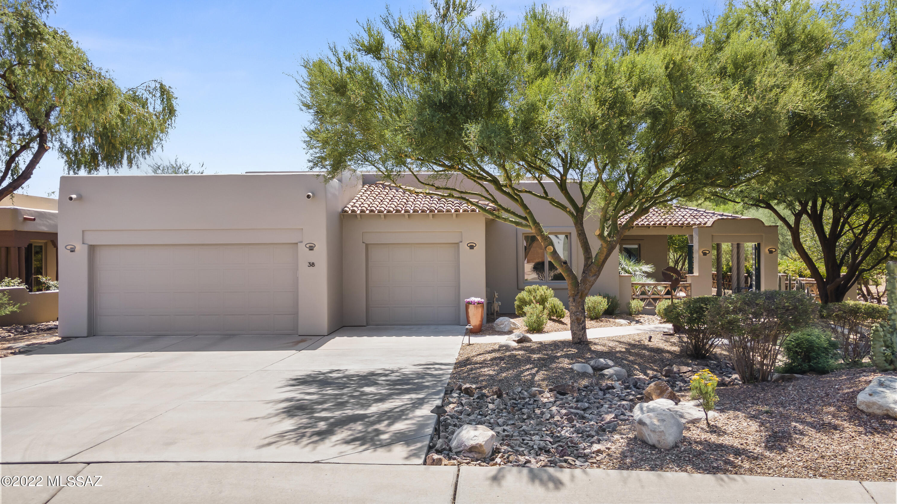 3 Bedrooms / 2.5 Bathrooms/Oversized 3 Car Garage
This beautifully updated home offers a modern twist on Southwest Territorial style, creating an elegant yet relaxed atmosphere. The interior is filled with natural light and provides a spacious layout perfect for entertaining, while maintaining an intimate feel ideal for comfortable living.
Recently updated, the home is move-in ready. The open living space overlooks a beautiful riparian cottonwood forest with views of the Santa Rita Mountains and flows into a newly remodeled kitchen. Custom touches by Tumacacori Mesquite Sawmill are featured throughout. The east-facing rear courtyard includes a Kiva fireplace with built-in seating and a large covered porch, perfect for relaxing and entertaining.