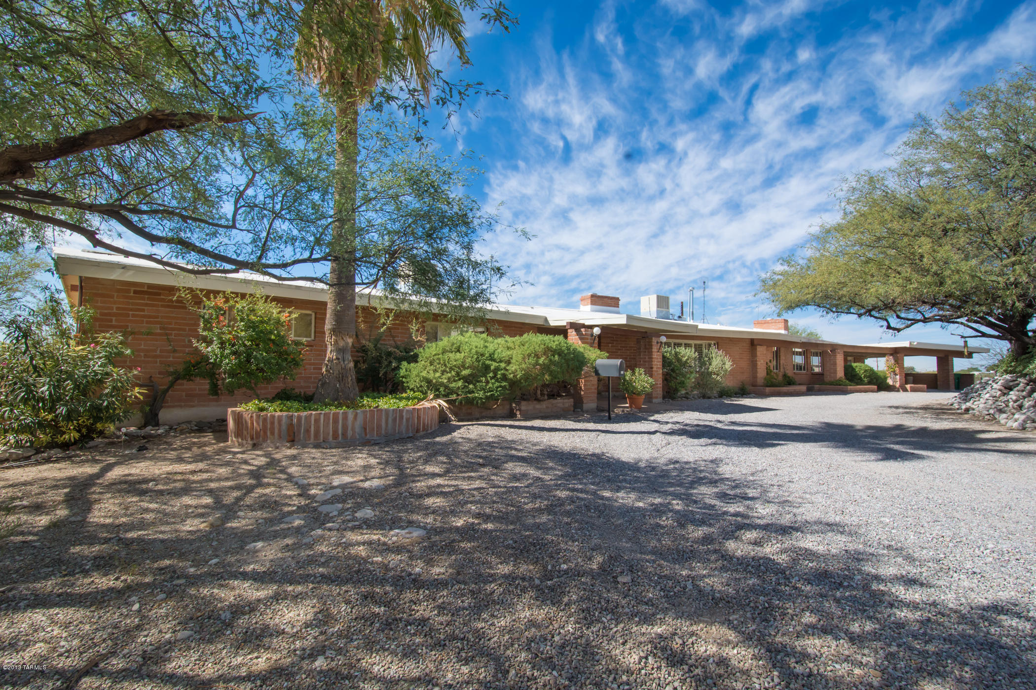 Remarkable Mid-Century Home located on glorious, private View Acreage! Rare, sweeping views from high above the Tucson Valley! 1959 solid quality construction. Near-central location convenient to the best of Tucson; shopping, restaurants, recreation, TMC plus top private schools all near-by.  Wood beamed ceilings, rock fireplaces, and distinctive large rooms. Split bedroom design, with guest room and bath separate and private access to back yard. Don't miss the hillside party Ramada just steps from the sparkling pool. Unique charm the owners have loved since 1970! A home for your family to now enjoy and make memories!