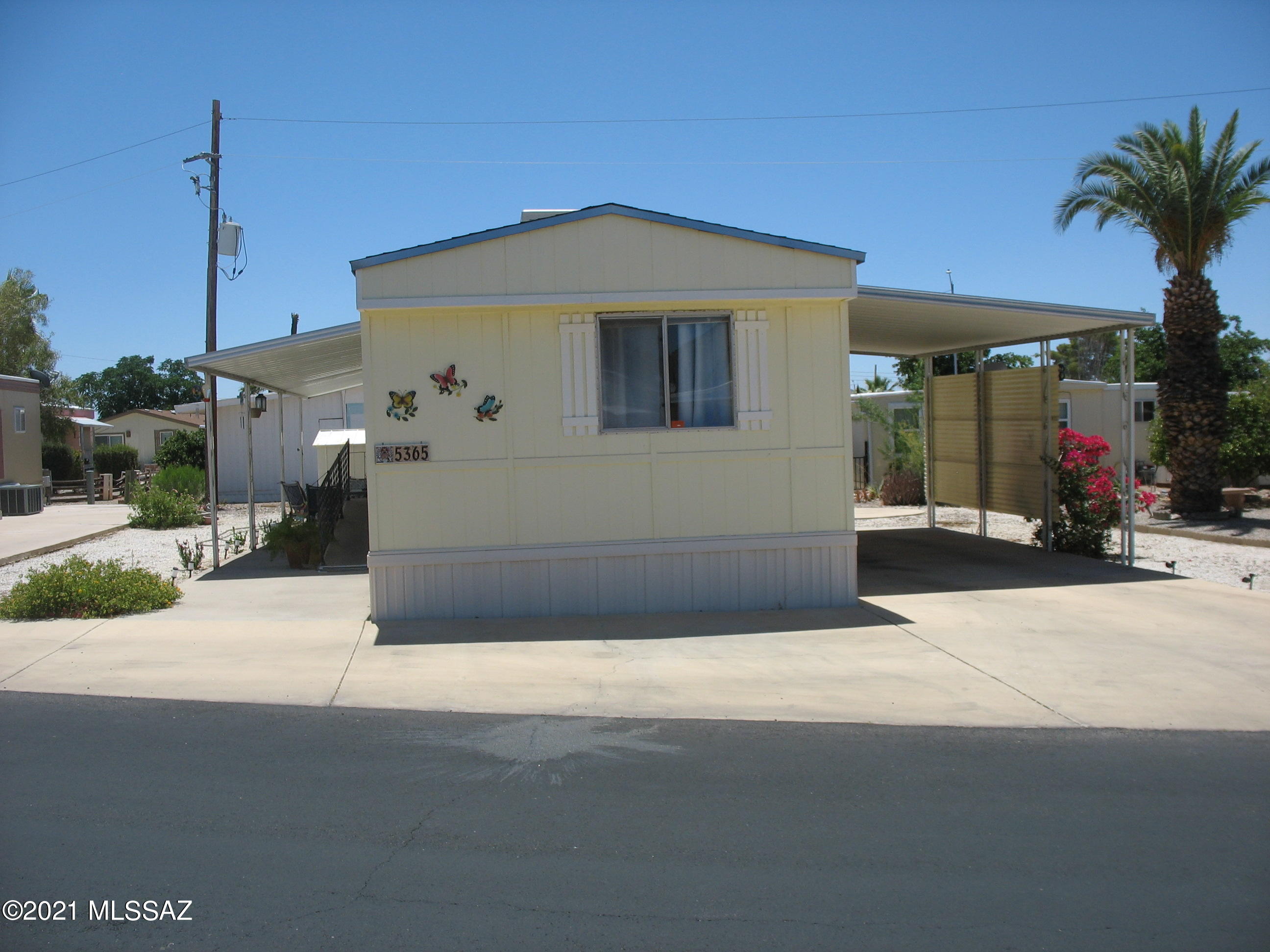 North facing 1978 singlewide with split bedroom floor plan and two bedrooms two baths.  Laundry in the main hall bath.  Open living room, kitchen, and dining area.  Evap cooler replaced in May 2021.  Poly pipes have been replaced.  Covered patio with mountain views on the east side.  Close to Sarasota.  The low $144 HOA fee includes unlimited golf, tennis, pickleball, shuffleboard, 3 pools, spa, exercise room, trash collection, and a lot more. Also included is the full use of separate buildings for card games, billiards, dances, concerts, educational forums, church services, and other social gatherings.  Tucson Estates is a safe and caring community.  You own the land, no lot rent!