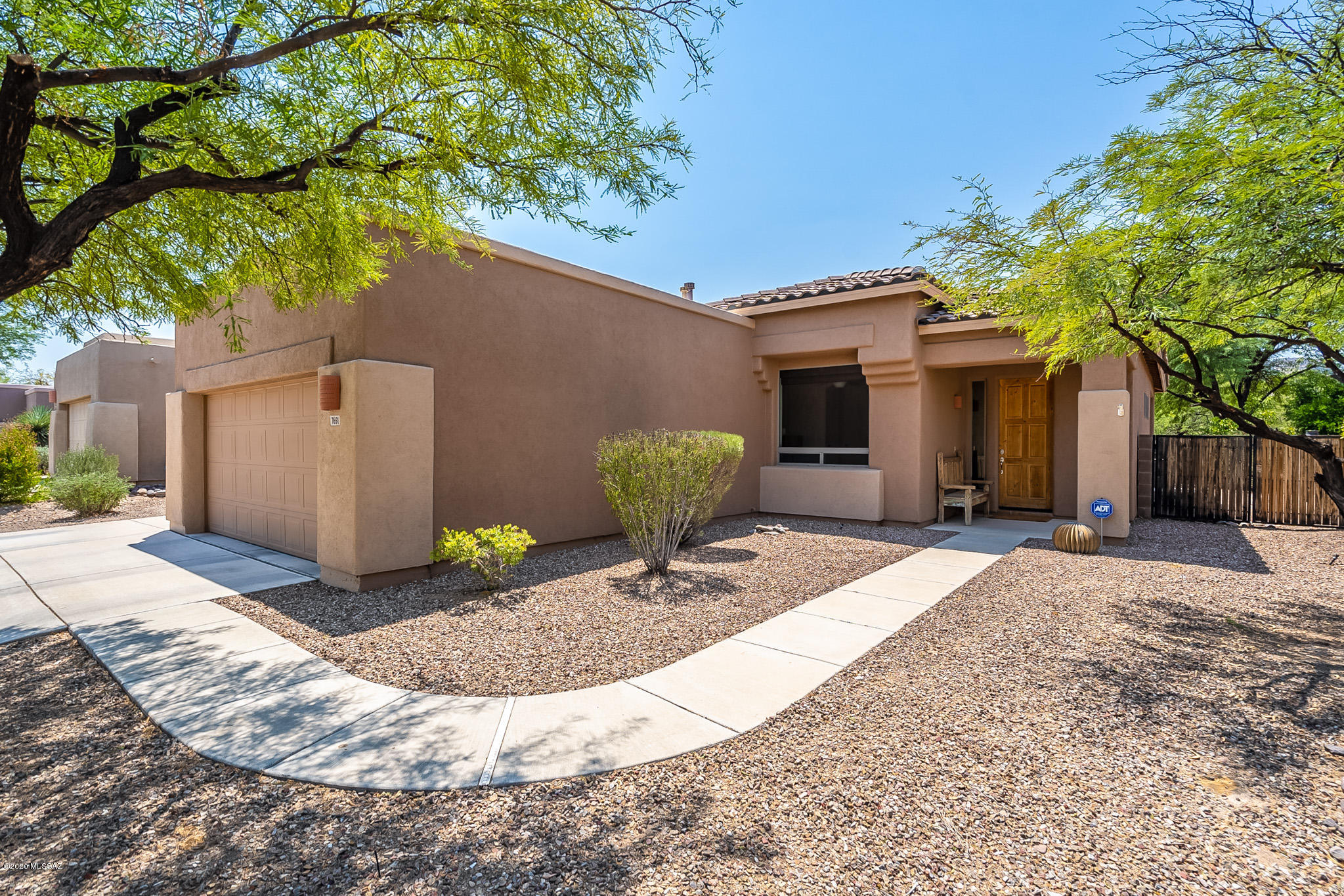 Exceptionally well maintained 3BR/2BA home located in gated Sierra Crest (Community Pool/Spa as well) backing up to common area with stunning Sombrero Peak in the background.  Large, open floor plan features ceramic tile and carpet throughout the house.  Kitchen includes stainless appliances and granite counter tops.  Owner's suite offers plenty of space along with dual vanities in the bathroom, complimented by a large, walk in shower.  Bonus room at front of home can easily be family room or den.  Low care back yard with built in bbq and beautiful mountain views top off this fantastic, move in ready Marana home!
