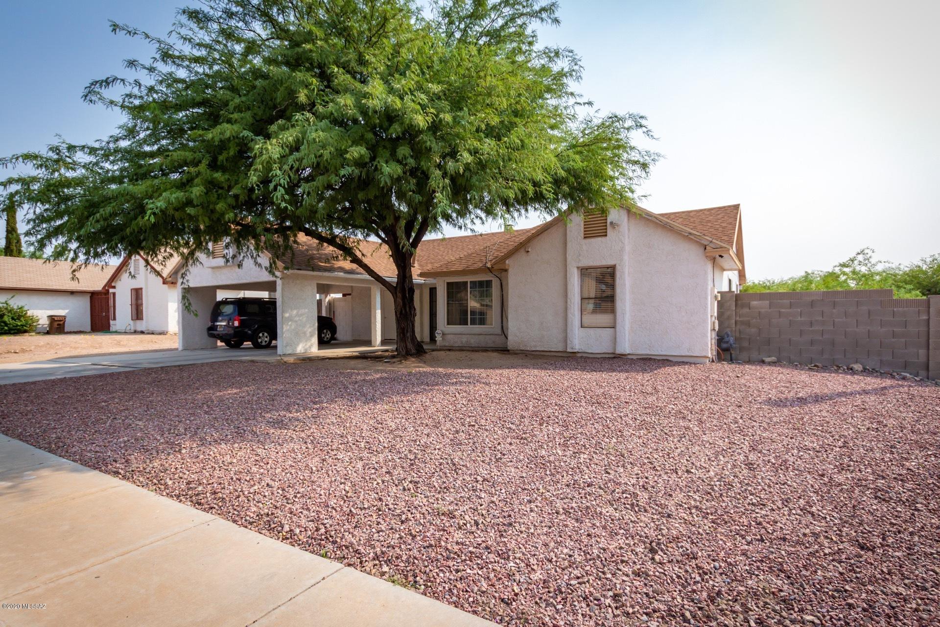 This-Attractive 4 bd, 2 bth, with a great room and cozy fireplace vaulted ceilings and plenty of space for entertaining friends and family in this bright kitchen . The master suite has a private bathroom ,with a generous-walk-in closet tile and wood floors throughout. Spacious  back yard . This home is ready for your personal touches.
